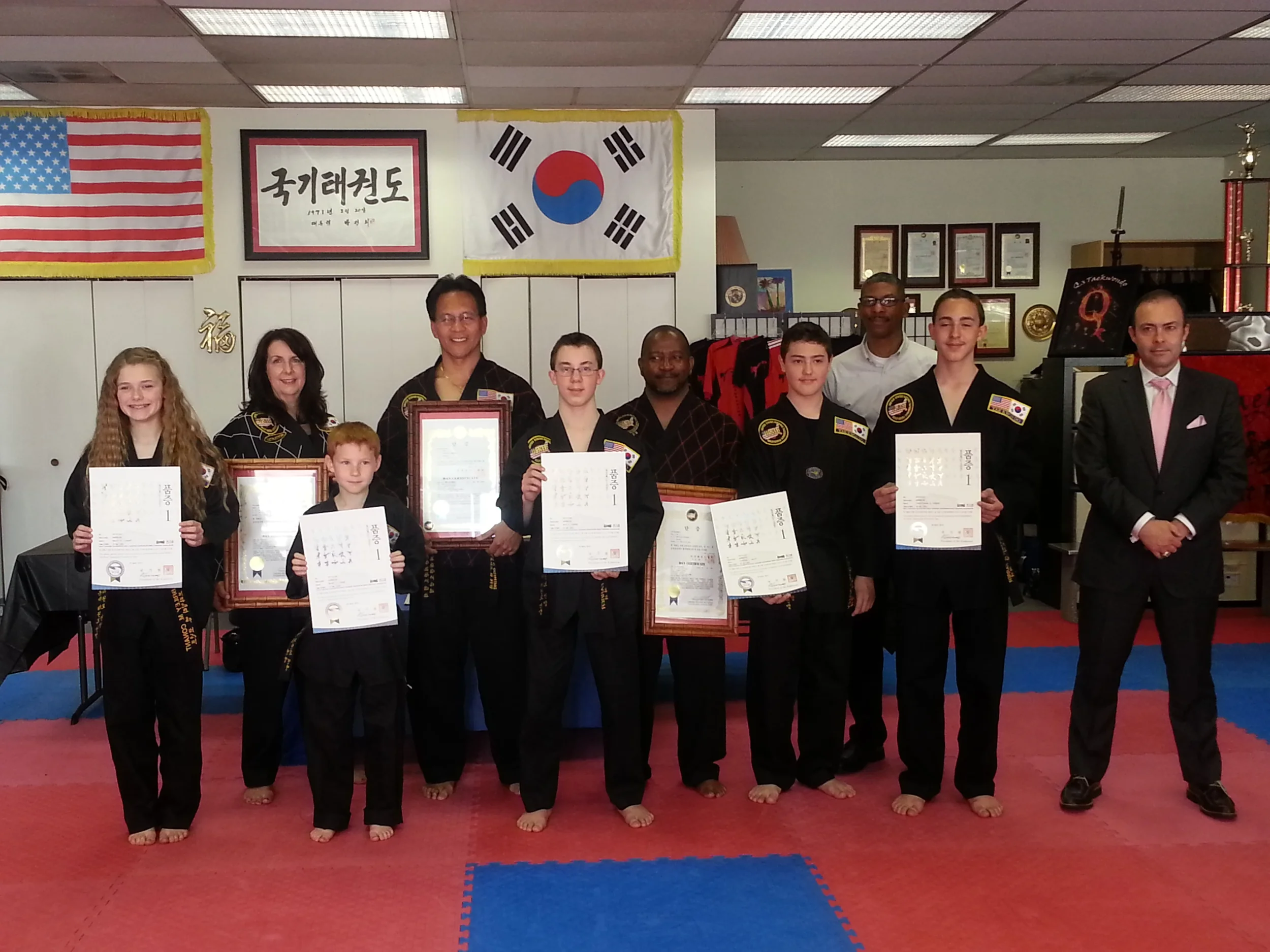 All of our new and promoted Black Belts display their certificates.