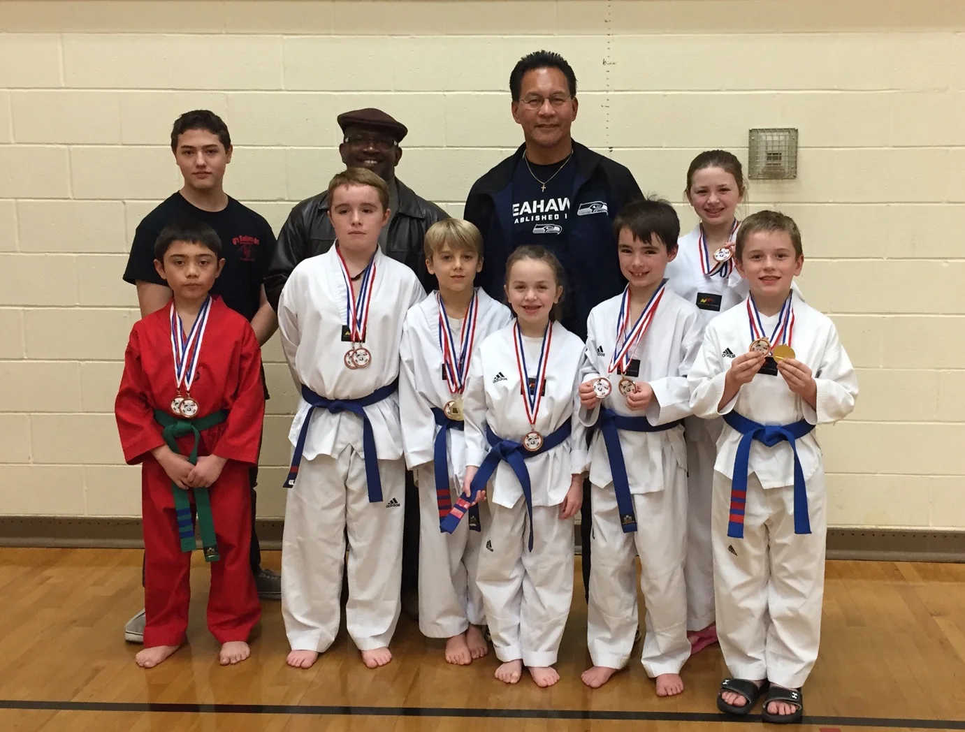 The team takes a group photo during an intermission (most of them have more medals to come)
