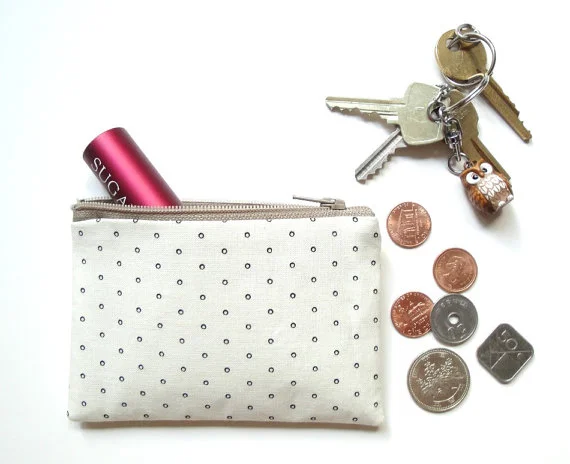 a small pouch for those little things, like lip glass, coins, and face spray (a must for flying)