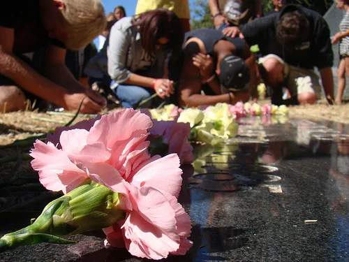 Survivors pray before the grave-site of thousands of aborted babies in a previous memorial in Los Angeles County, CA