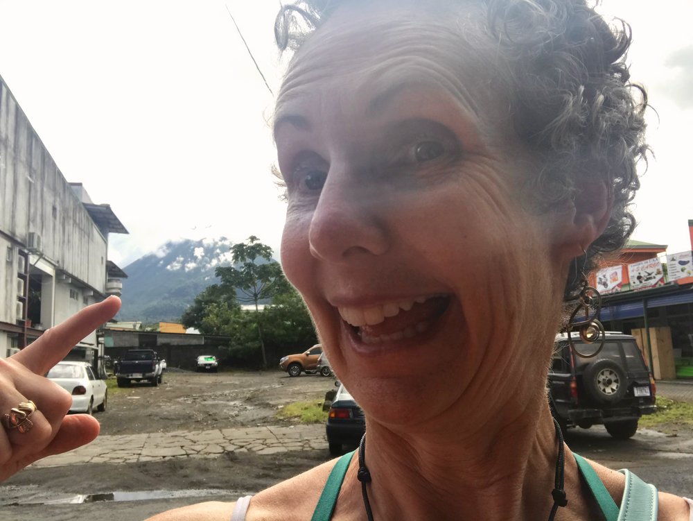  Well, she is either pointing to Volcan Arenal, to what 156% humidity does to your hair, or that look you have after spending two weeks with your kids in another country. 