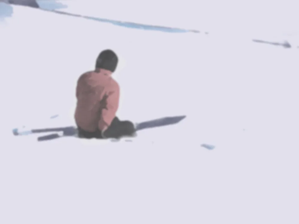 Askier-sitting-ski-slope-looking-down-38127725.webp