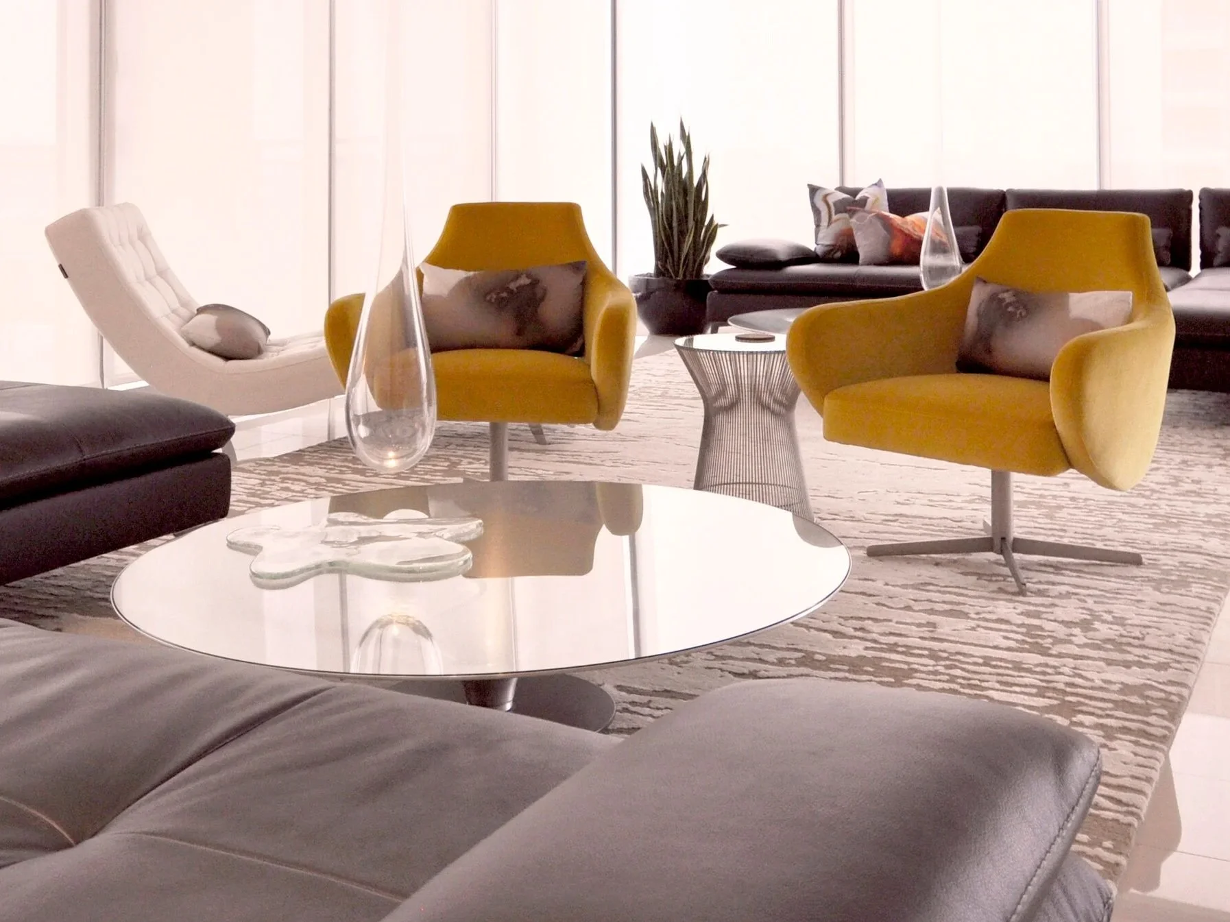 Modern living room with yellow and white armchairs, black sofa, glass vases, and a large window with blinds.