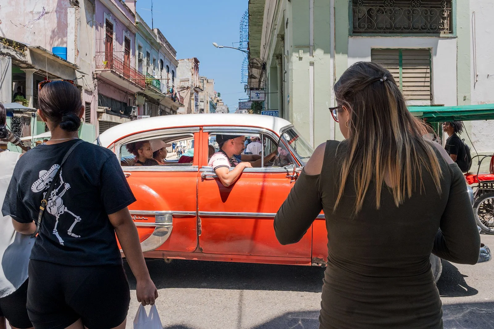 Classic car on the street in Havana Cuba filled with people