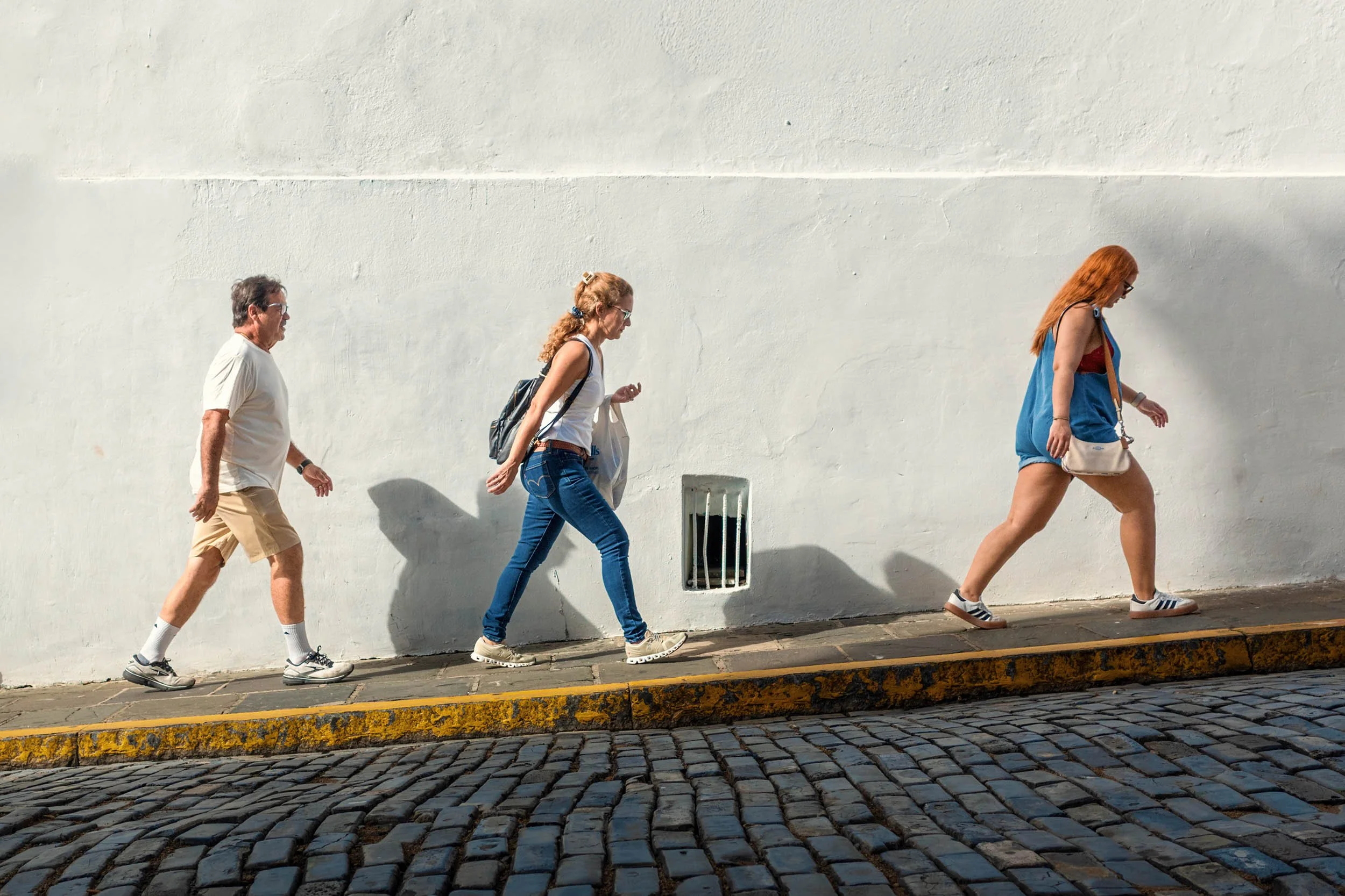 Tourists walking a cobblestone street in Old San Juan Puerto Rico