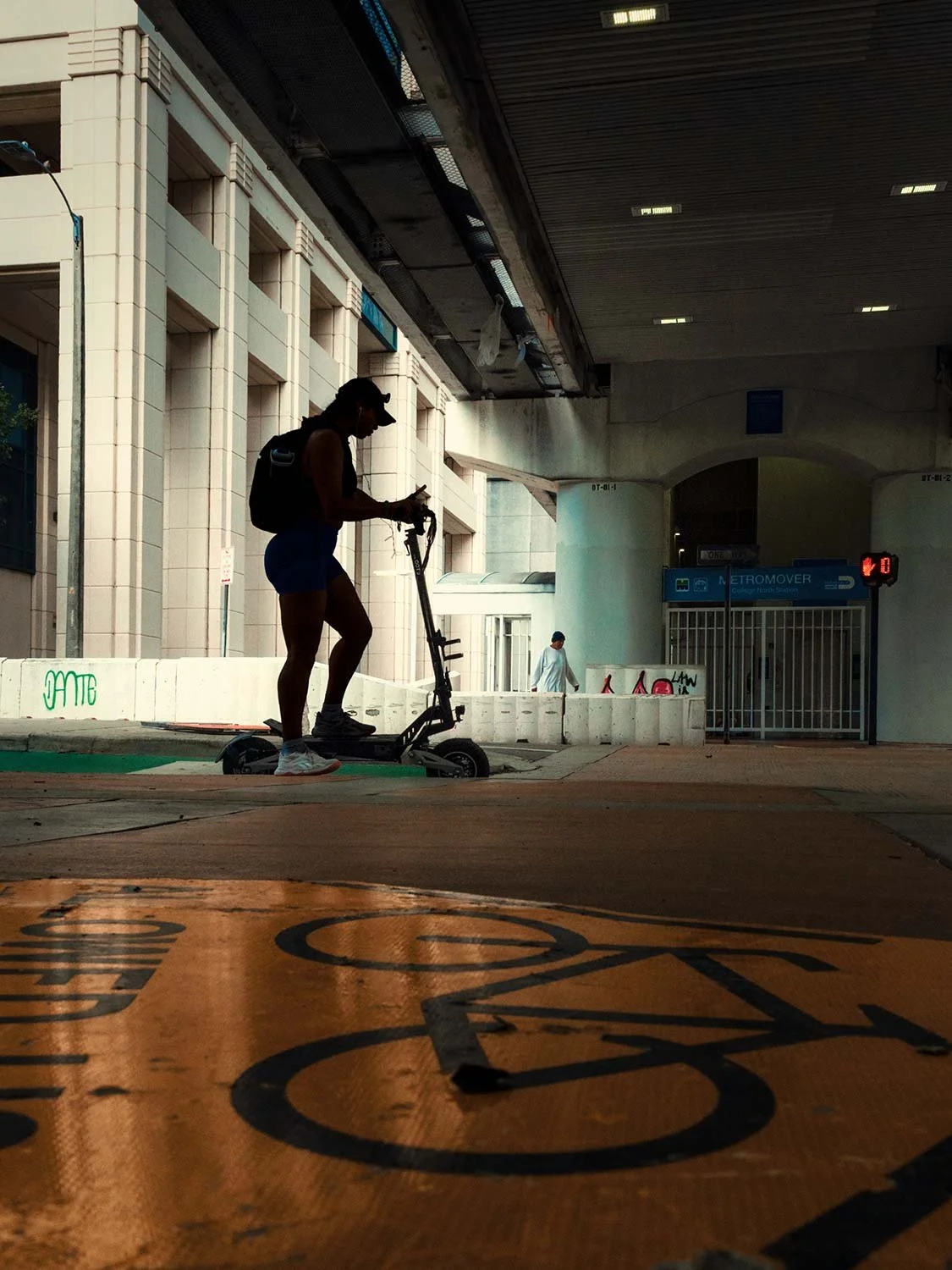 Riding a scooter in a silhouette in downtown Miami