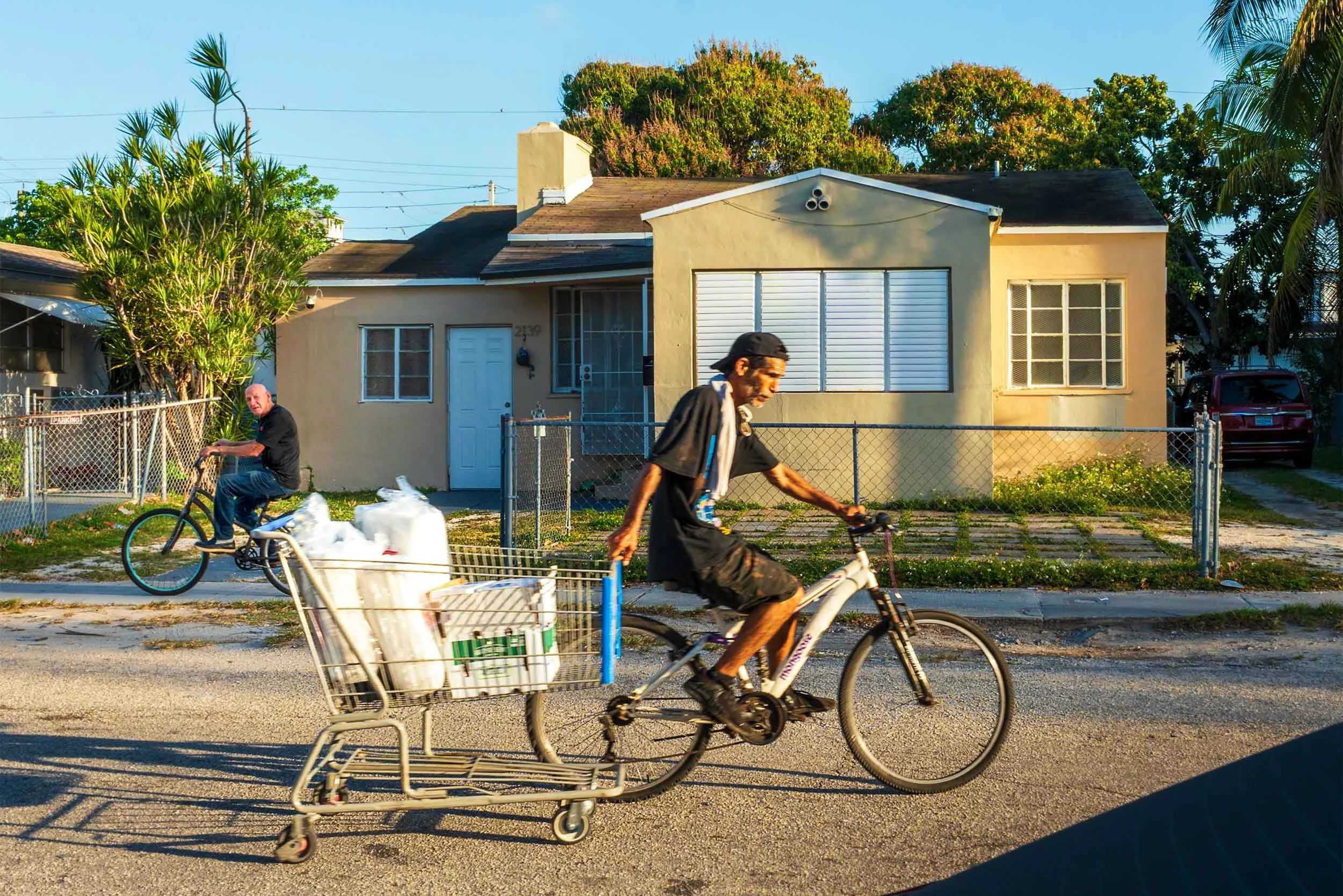Man riding a bicycle and pulling a cart in Little Havana Miami