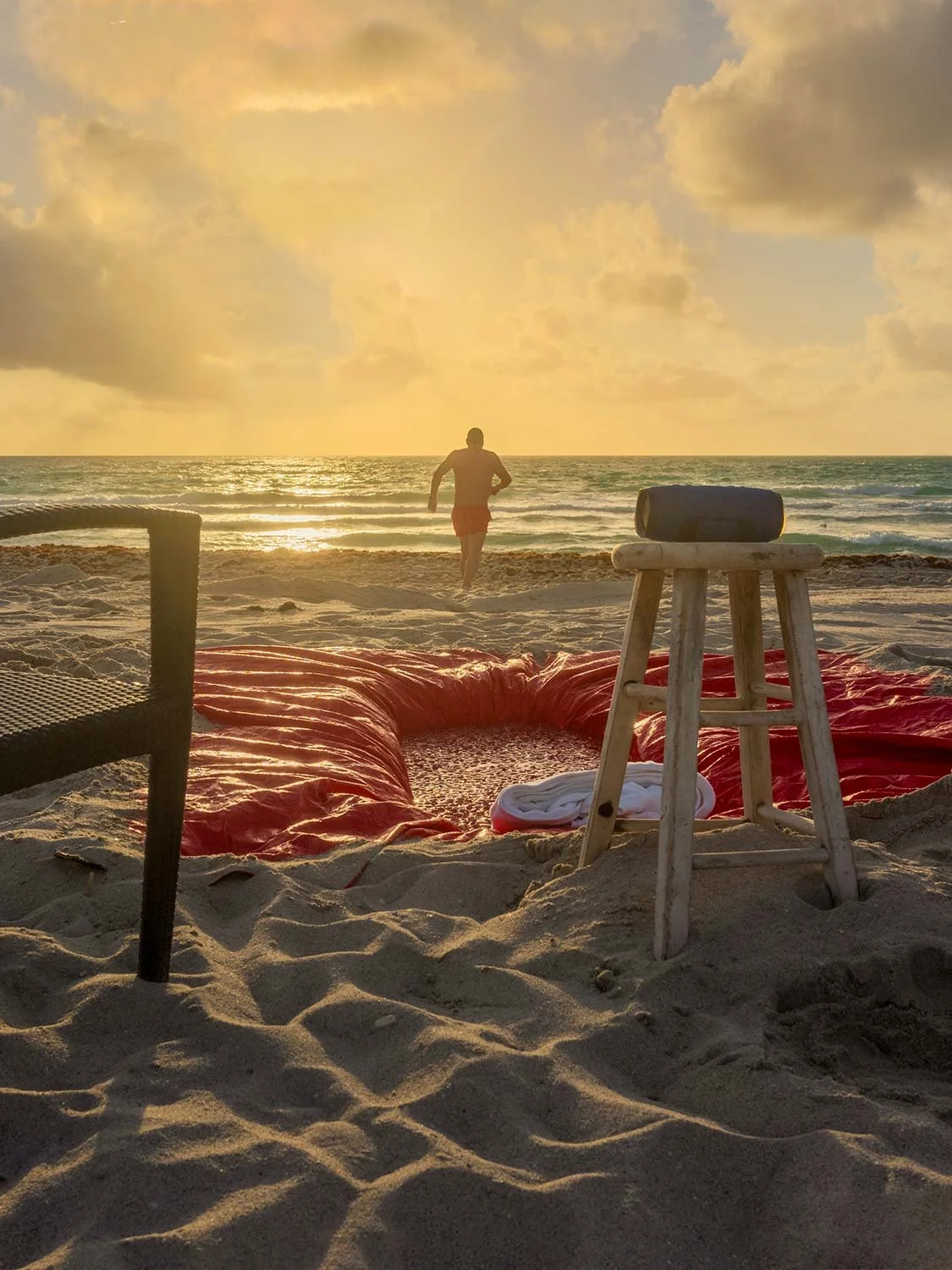 South Beach sunset ocean swim red blanket sandy shore golden hour Miami beach lifestyle photography