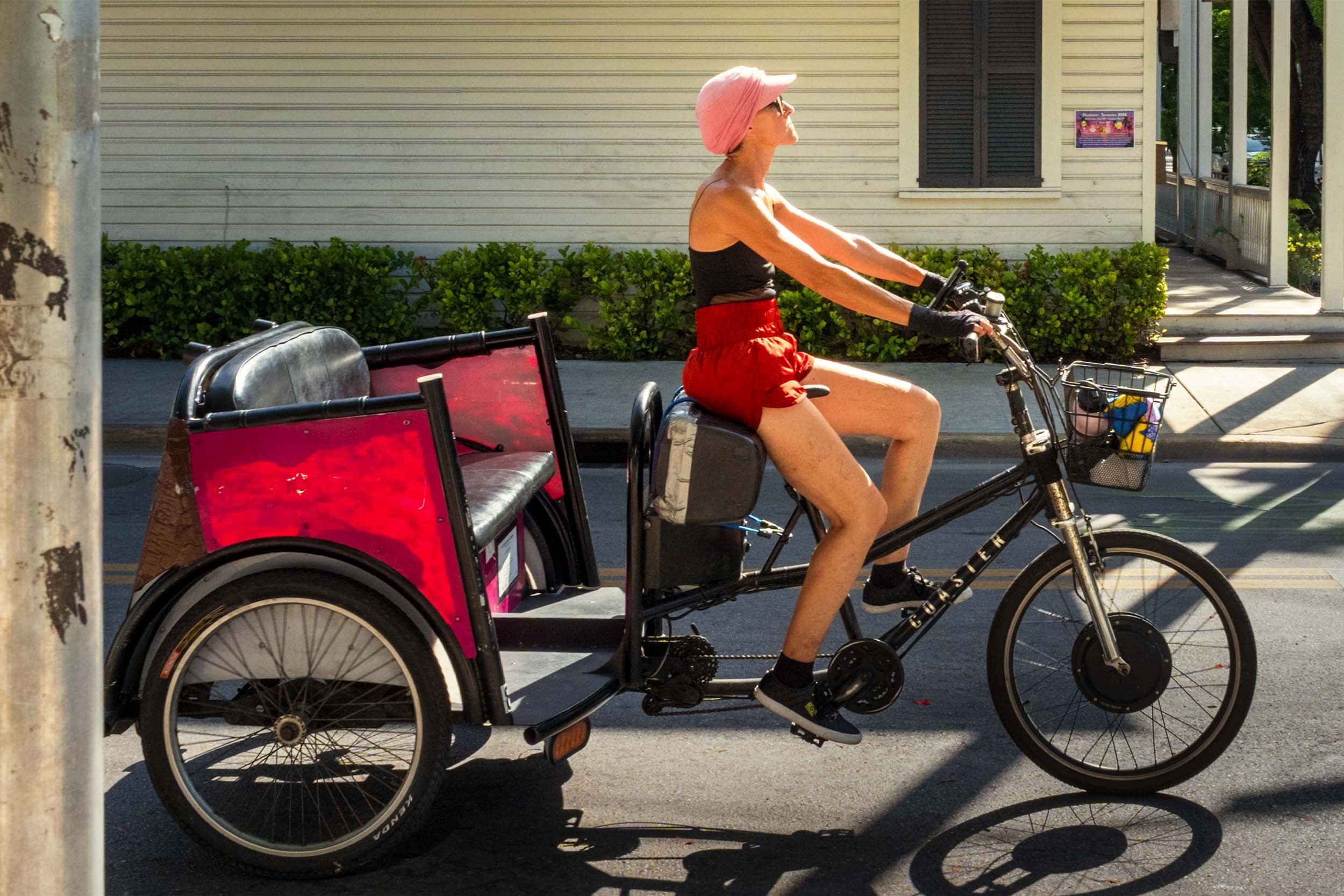 Key West pedicab ride | female cyclist on rickshaw tricycle | outdoor urban street photography Florida