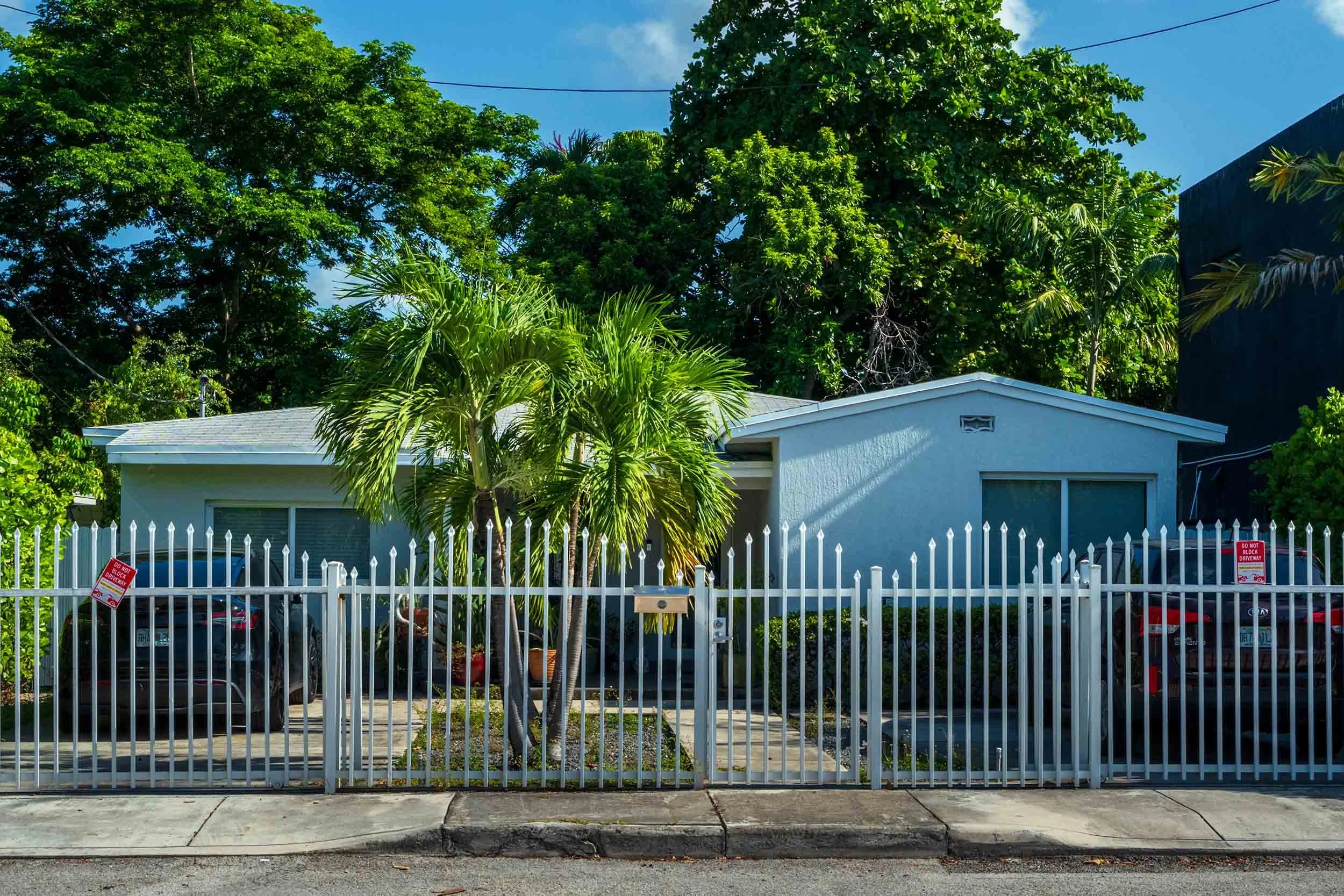 Blue Mission-style bungalow with palm trees, Buena Vista Miami street view