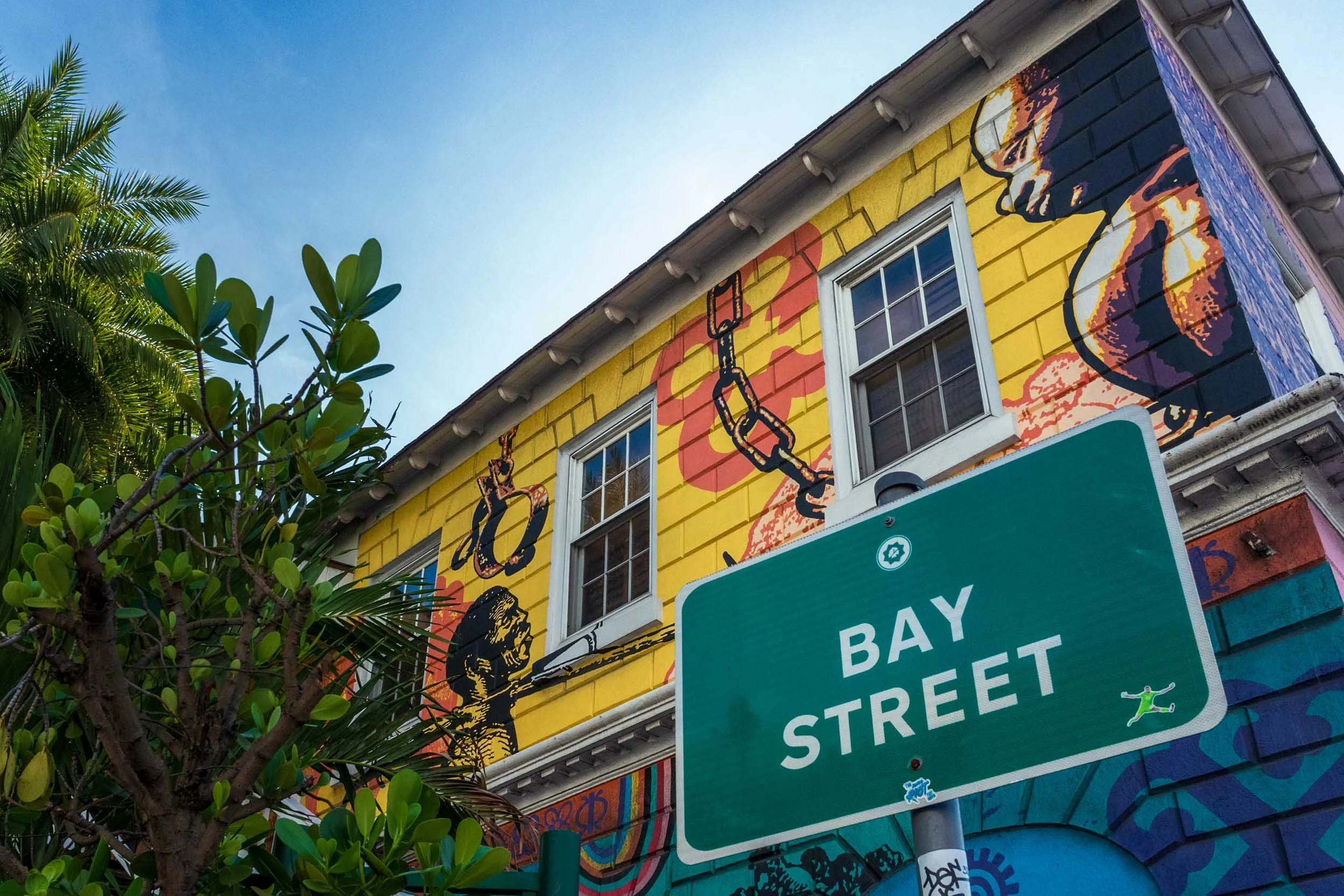 Bay Street street art mural yellow building urban graffiti tropical city neighborhood public art