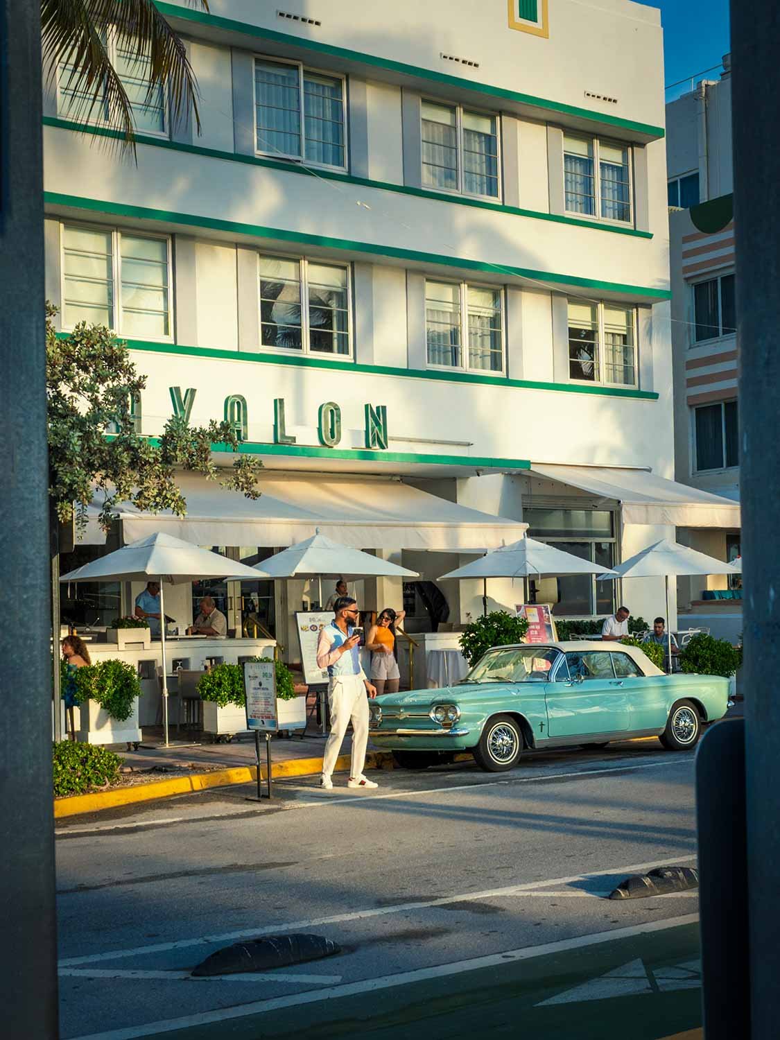 Classic car parked in front an Art Deco hotel on Ocean Drive South Beach Miami, the Avalon