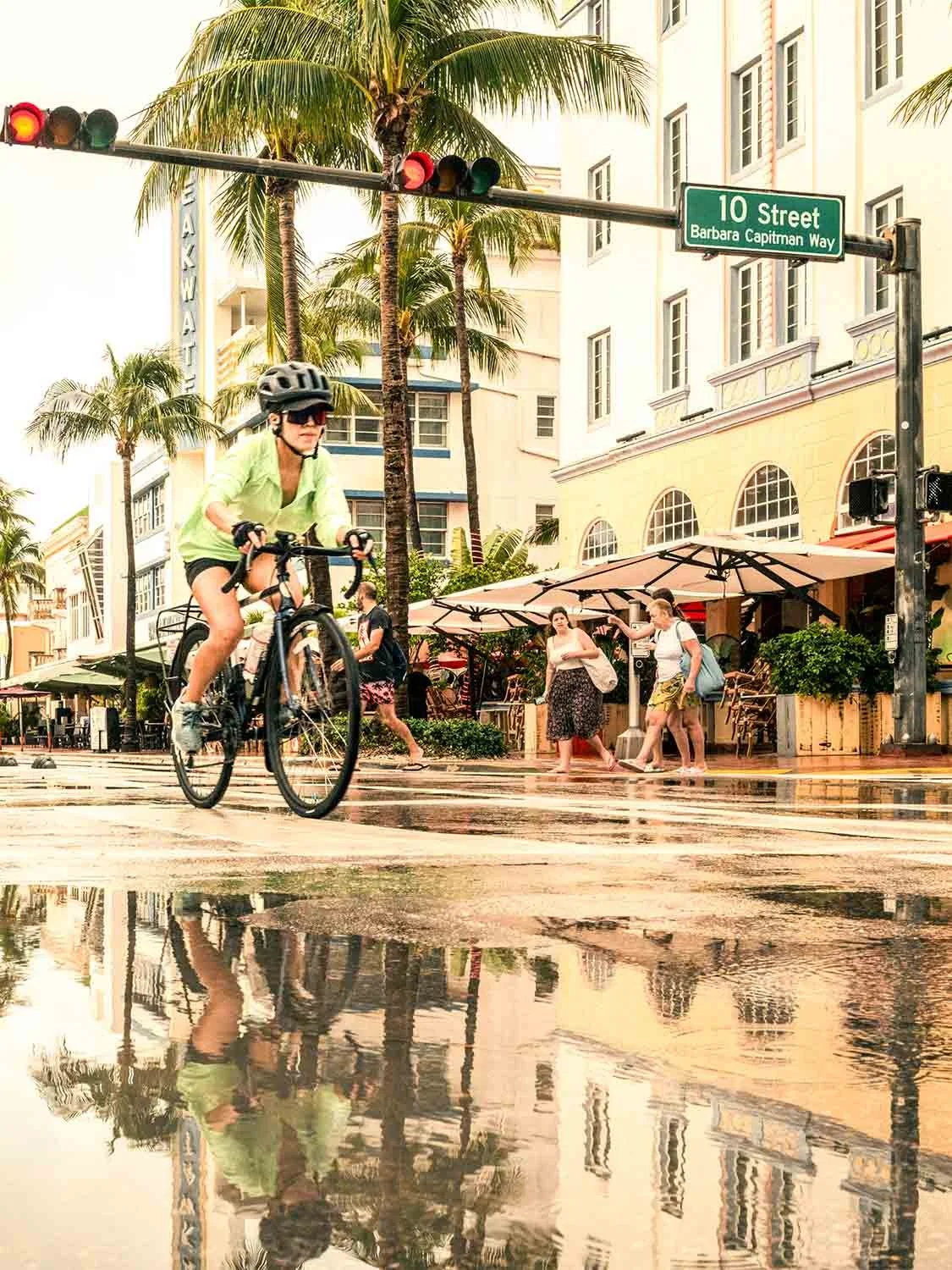 Miami Beach cycling Ocean Drive 10th Street rainy day Art Deco district palm trees urban bike commuter reflection