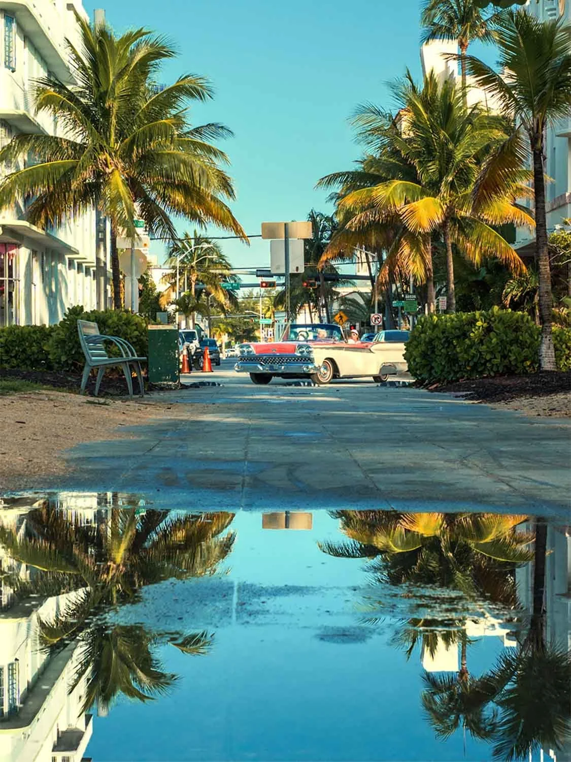 Classic car driving down Ocean Drive in South Beach Miami