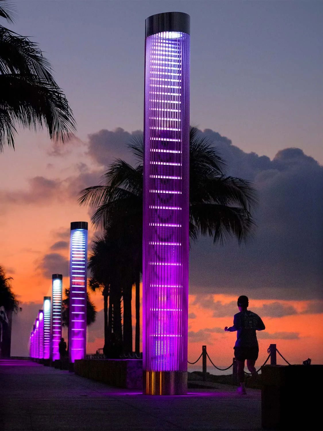 LED art installation South Point Miami Beach illuminated purple light towers sunset promenade outdoor public art Florida.