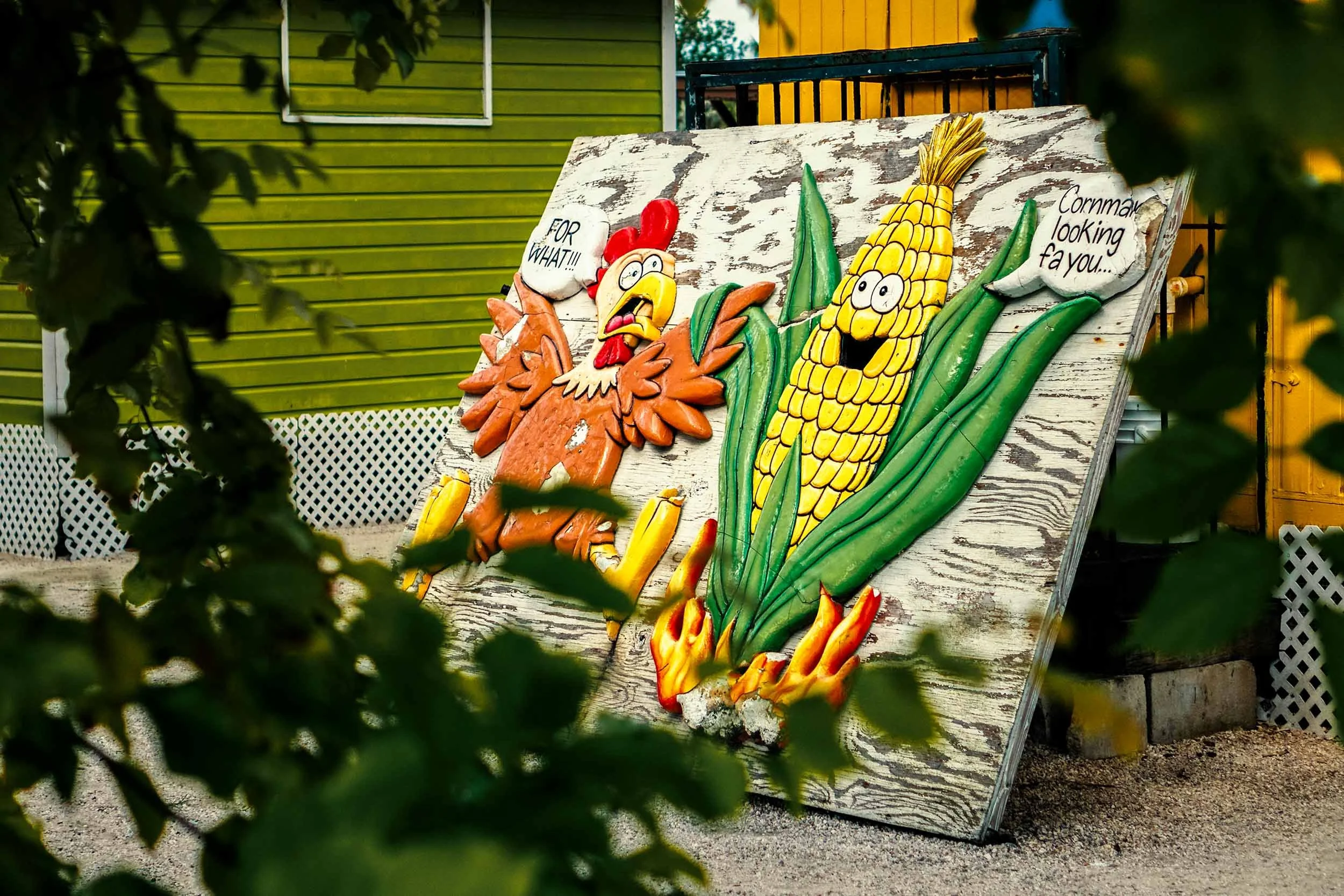 Rustic outdoor carved wood sign chicken and corn cartoon folk art roadside attraction restaurant decor