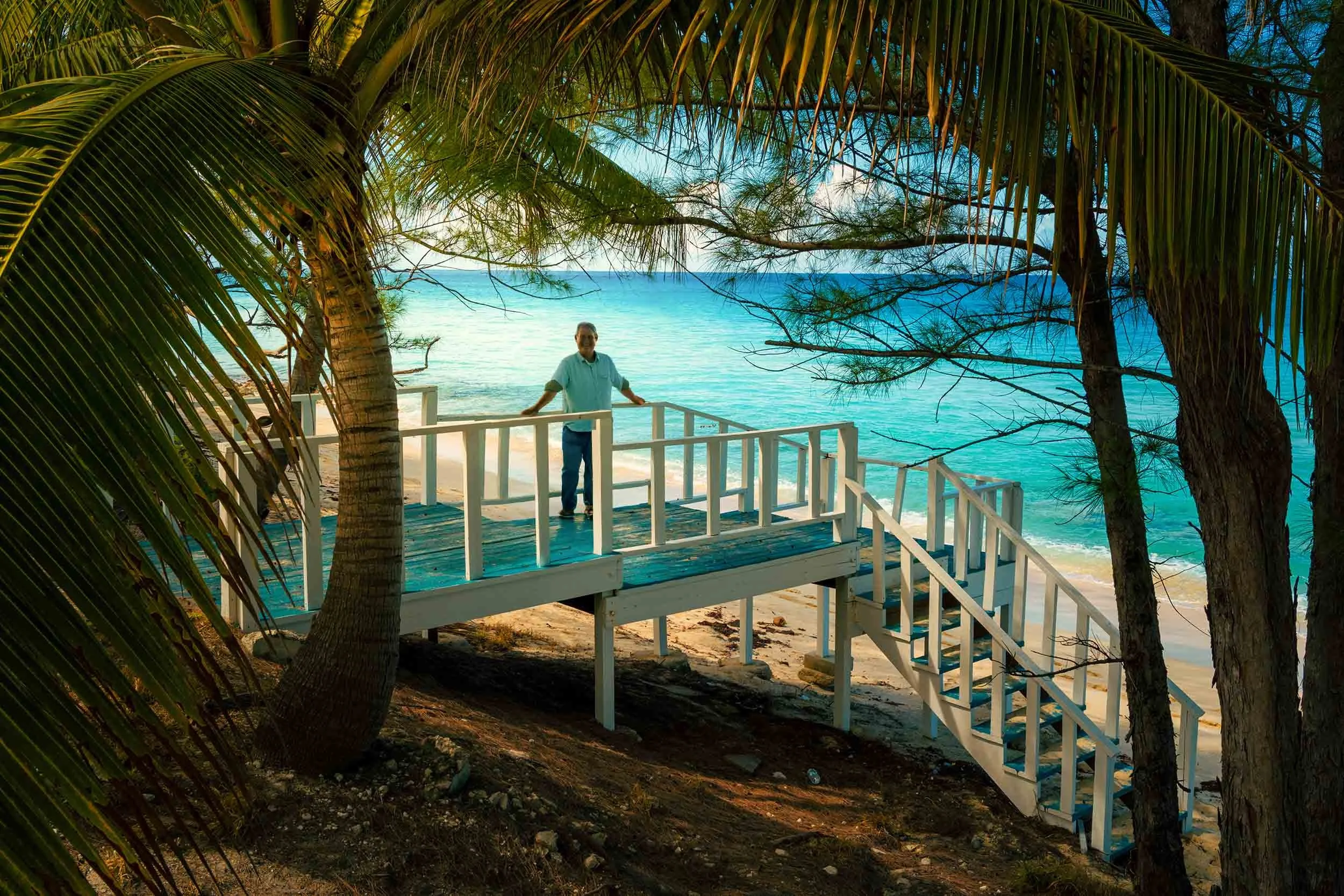 Standing under the shade of palm trees on the beach in Bimini Bahamas - Miami photographer