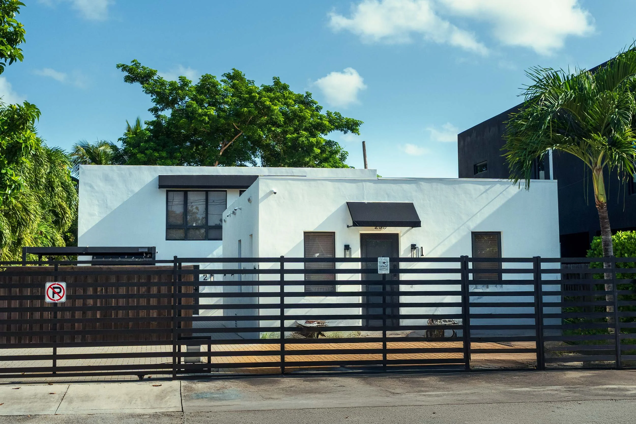 Modern white renovated home with black slat fence, Buena Vista Miami