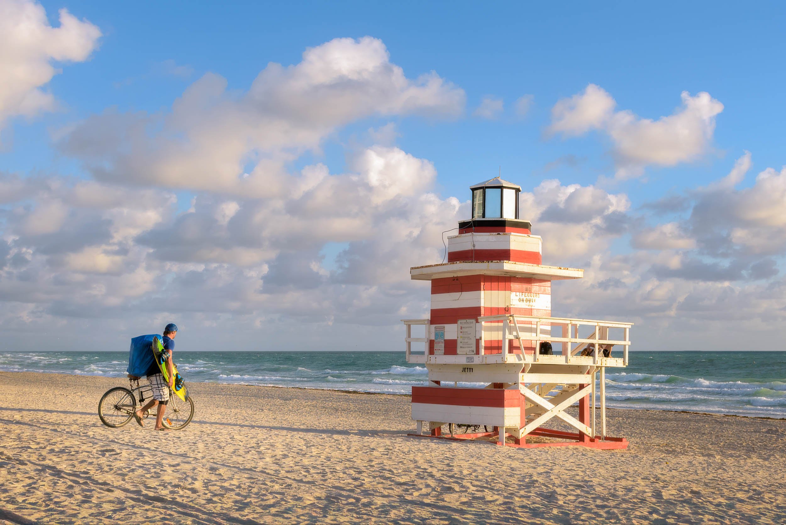 Iconic Jetty Lifeguard Tower on Miami Beach, standing tall against a sunny sky and calm ocean.