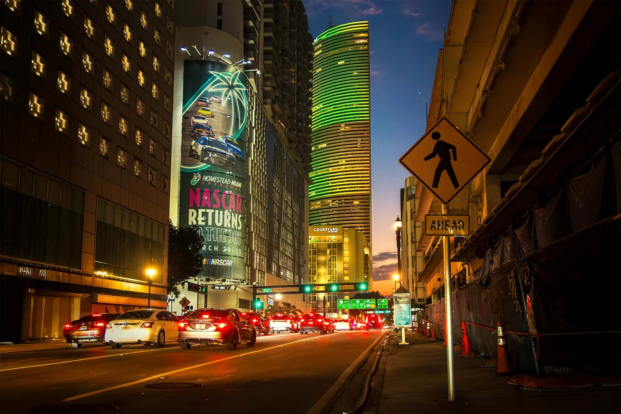 NASCAR Homestead-Miami Speedway billboard downtown Miami night cityscape urban advertising March race event.
