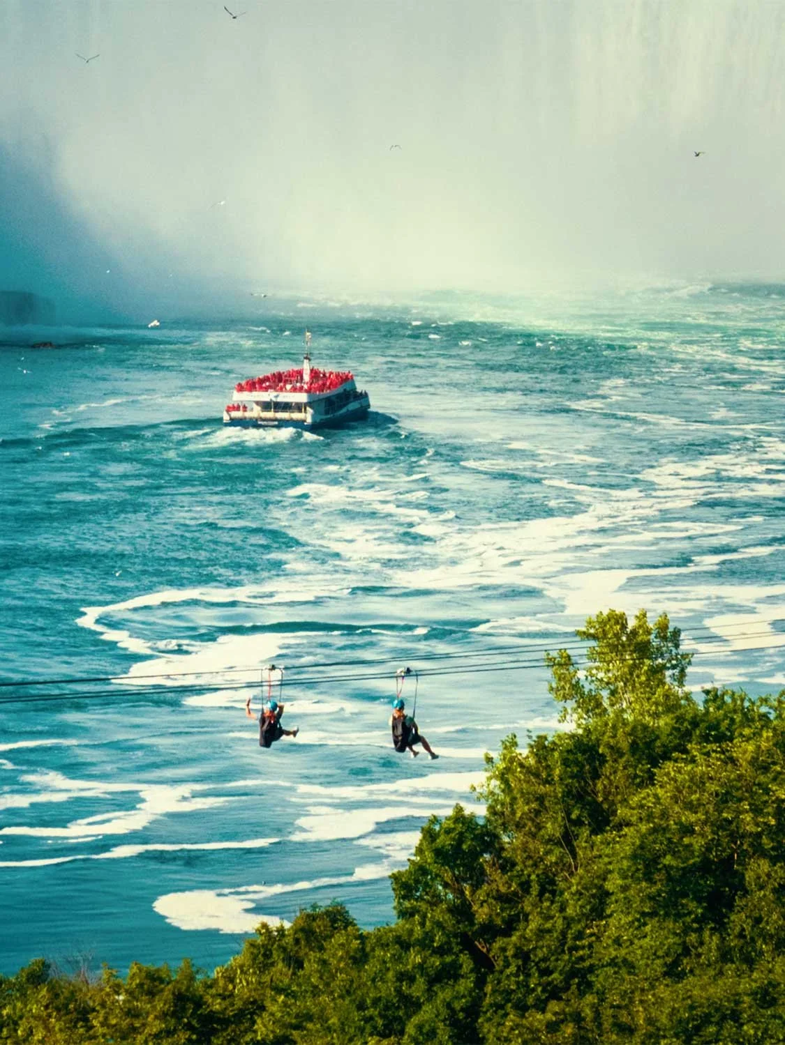 Niagara Falls zipline tour with Maid of the Mist boat, turquoise rapids, and waterfall mist aerial adventure