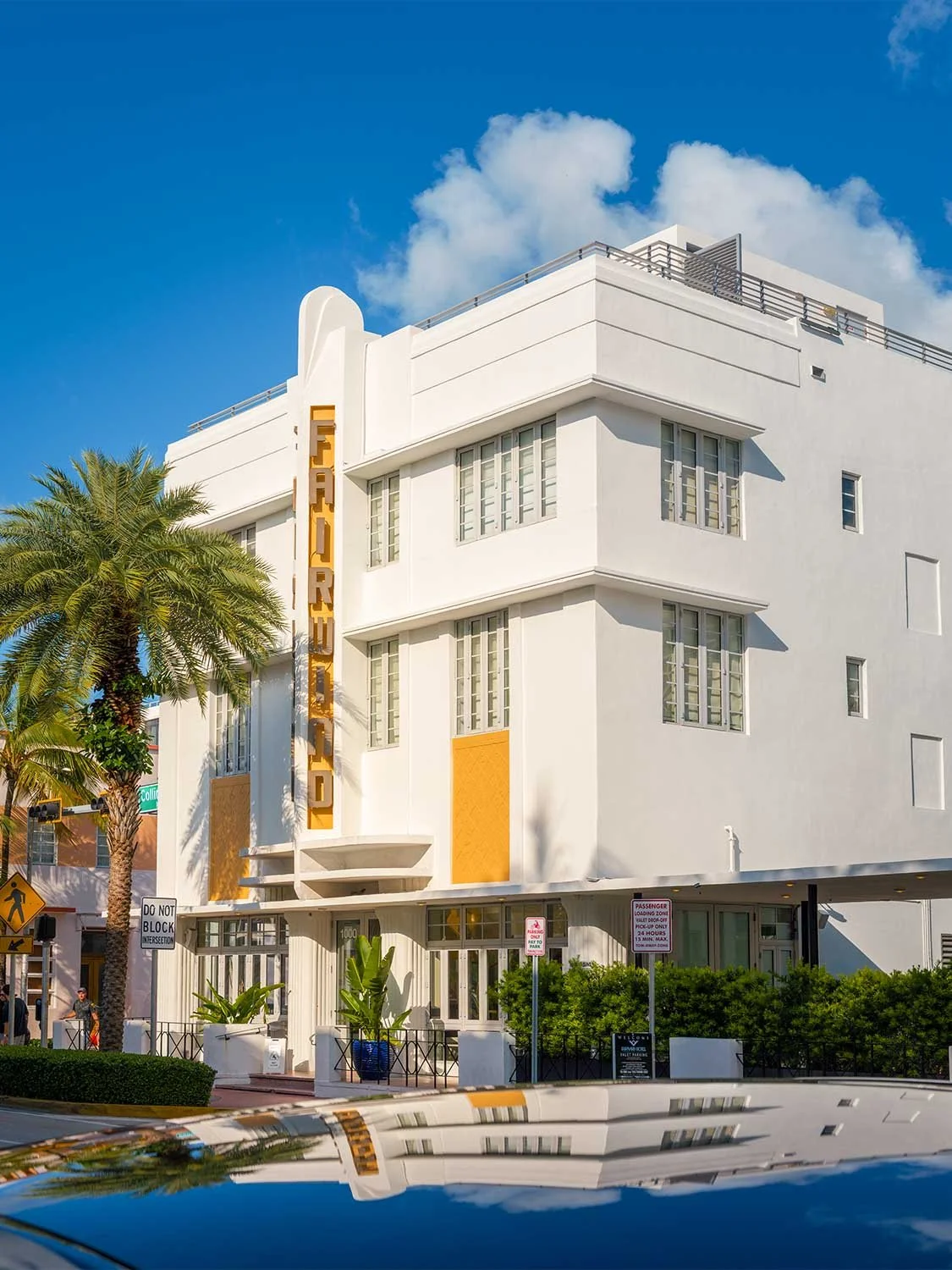 South Beach Art Deco hotel exterior Miami Beach historic architecture white building palm trees blue sky