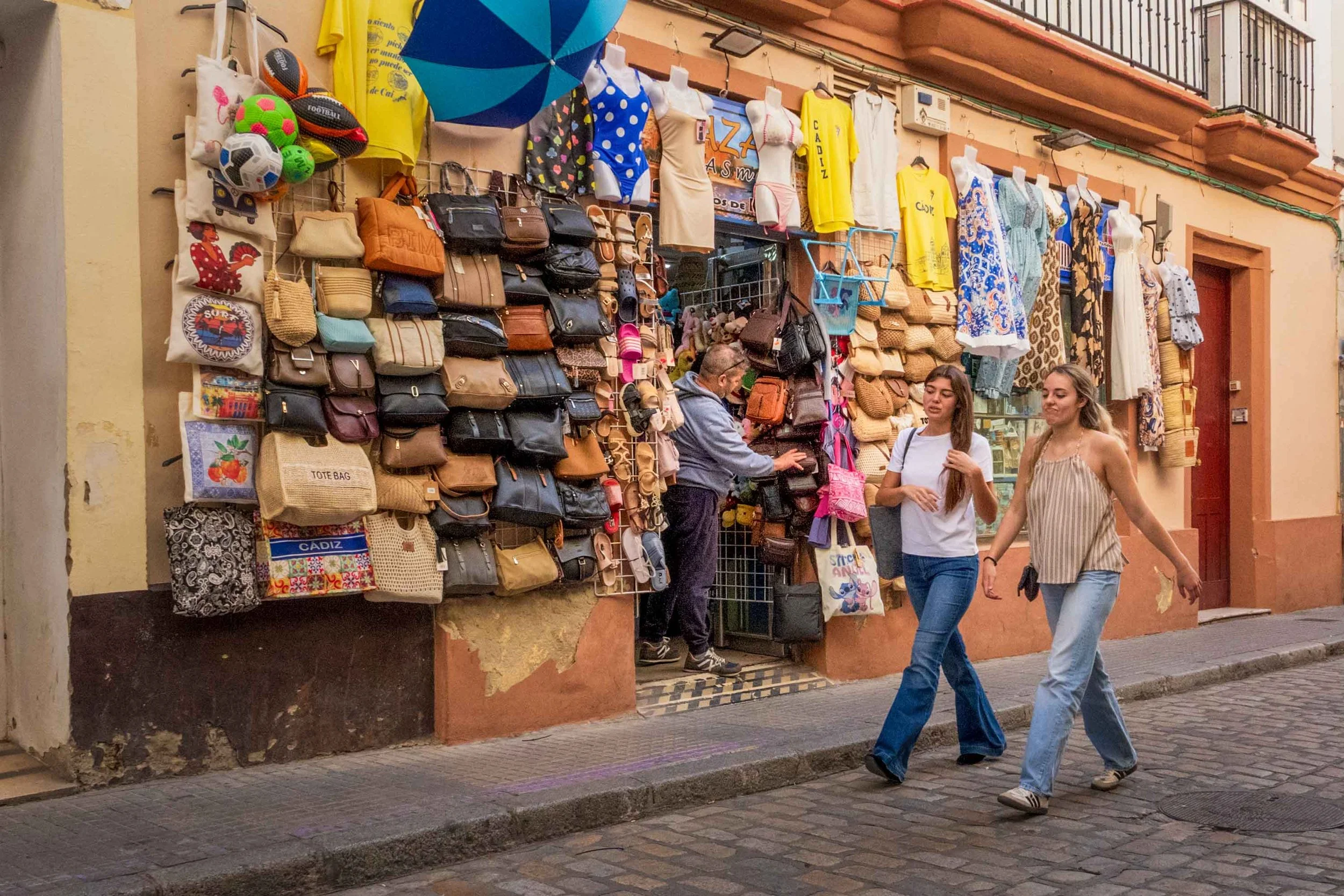 Cadiz Spain street market handbags souvenirs outdoor shop tourists walking historic old town Andalusia travel shopping