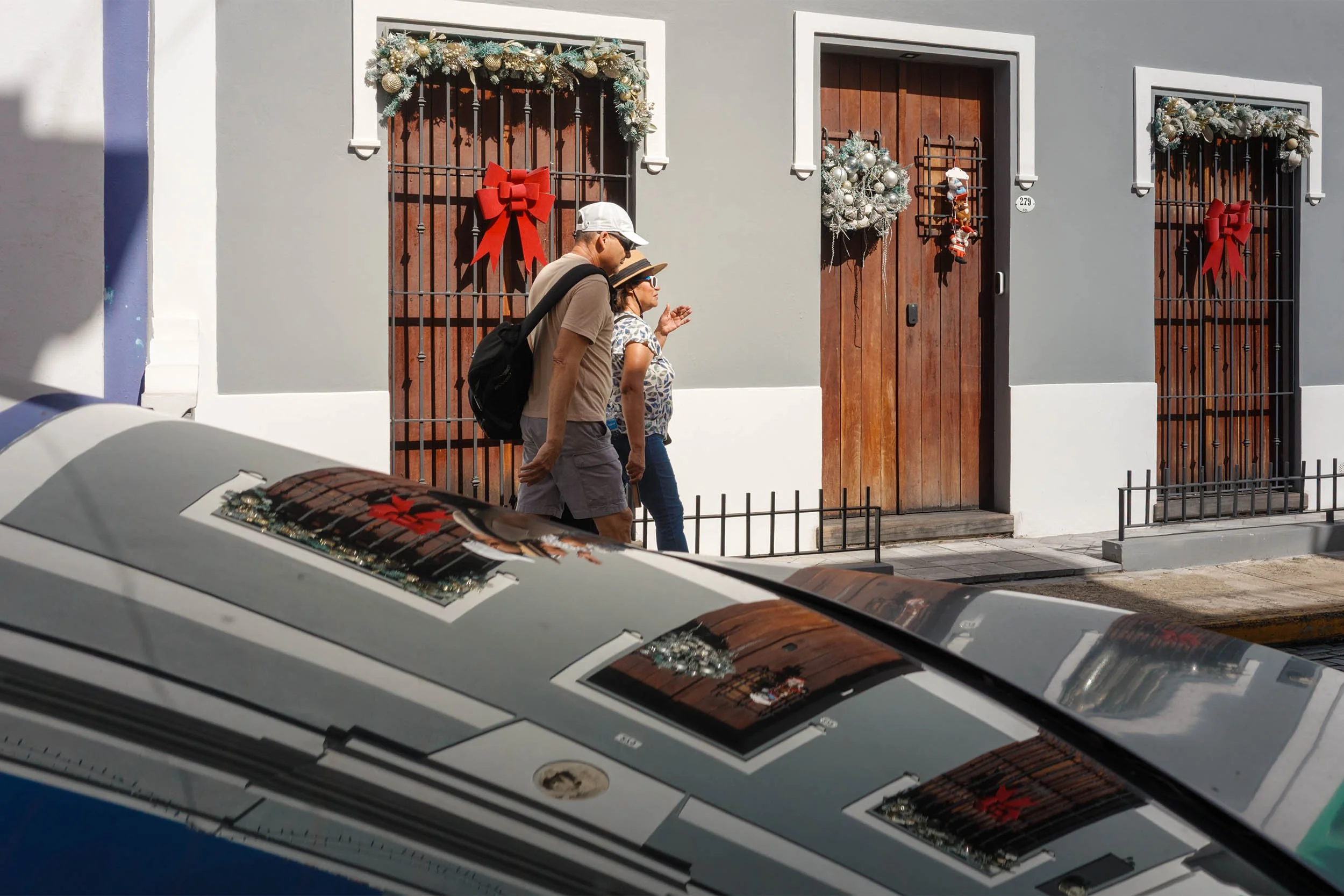 Tourist walking one of the colonial streets in Old San Juan Puerto Rico