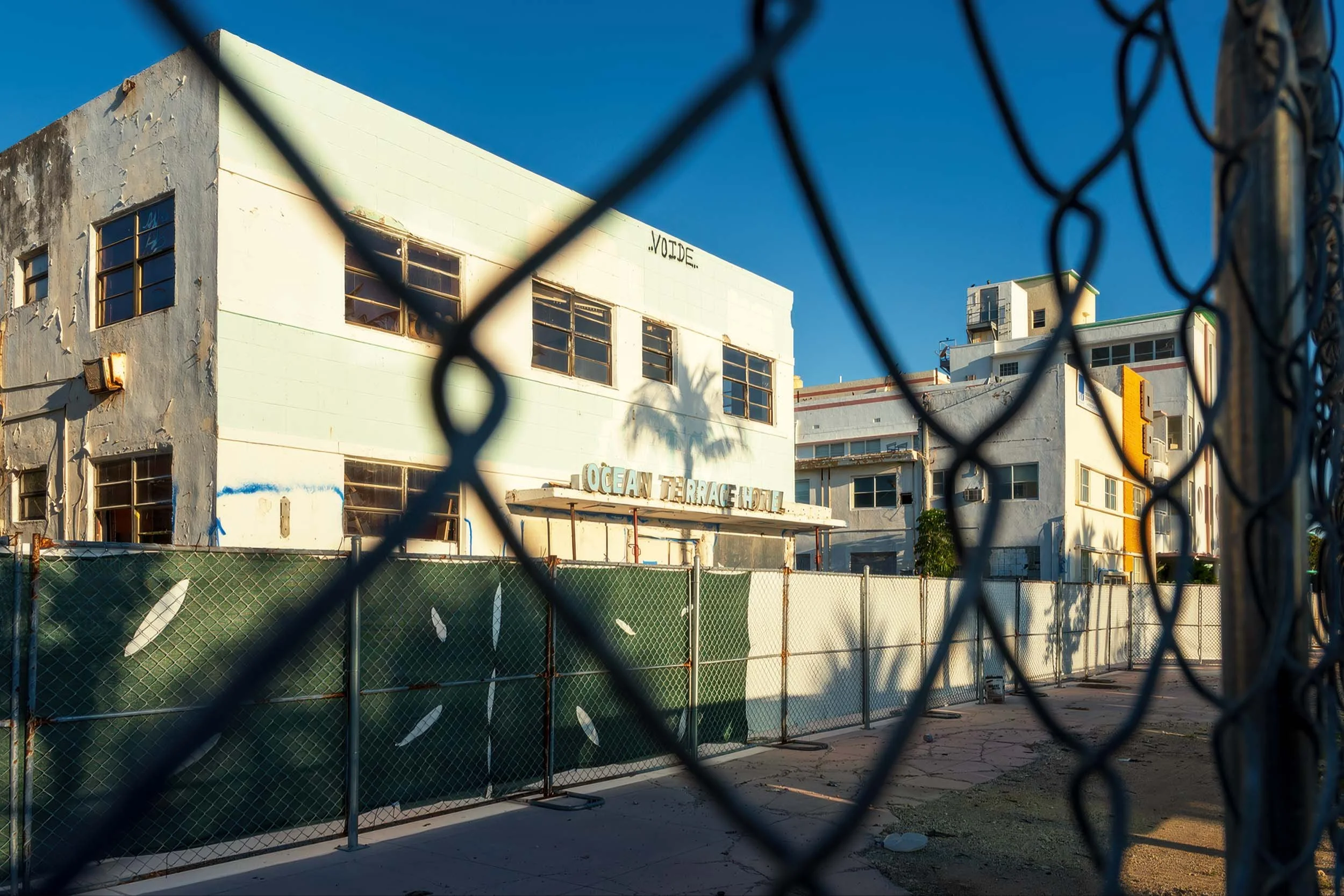 Ocean Terrace Hotel facade at 7410 Ocean Terrace shot through construction fencing