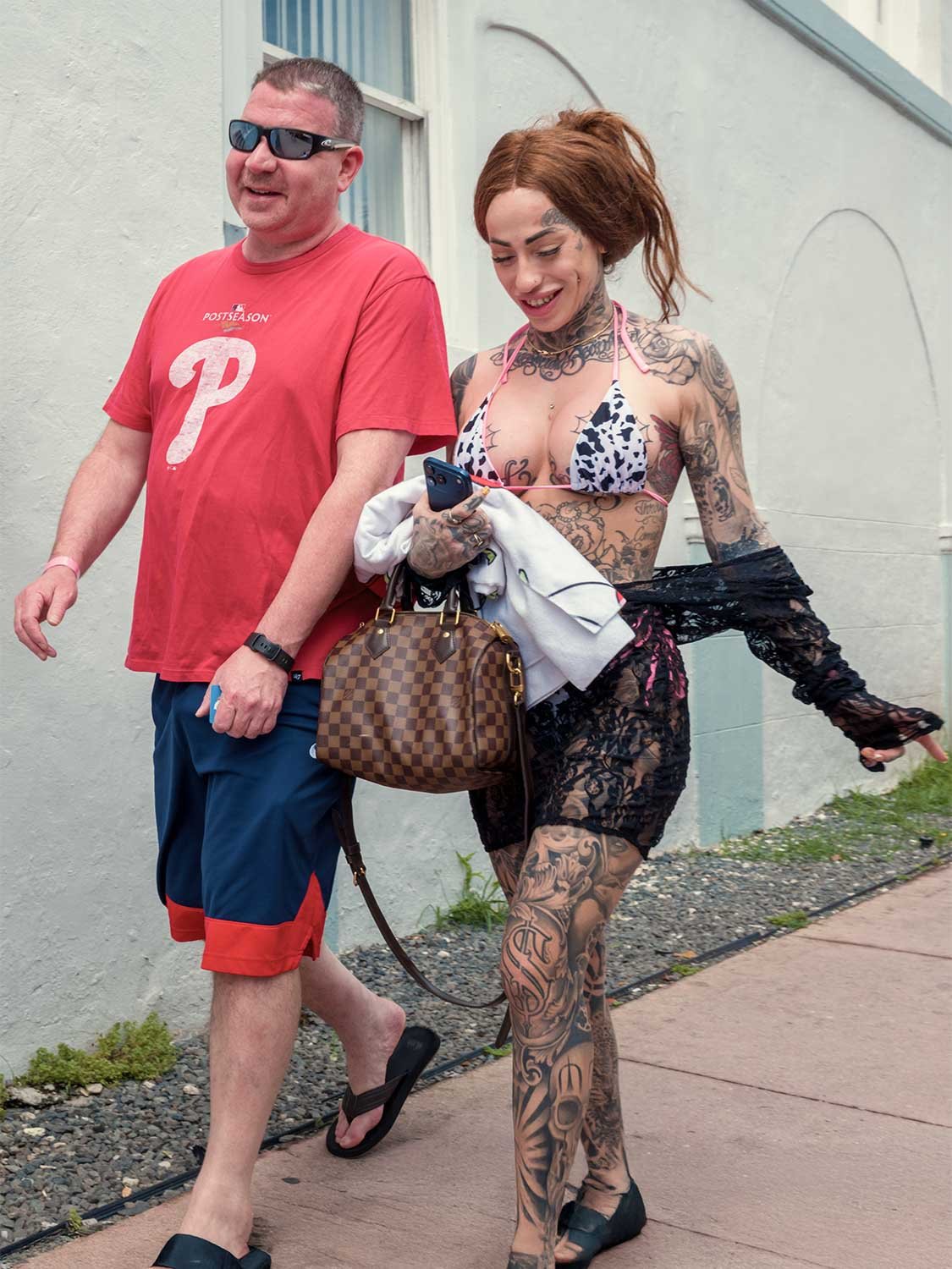 South Beach street style tattooed woman bikini Louis Vuitton bag walking outdoors urban fashion photography