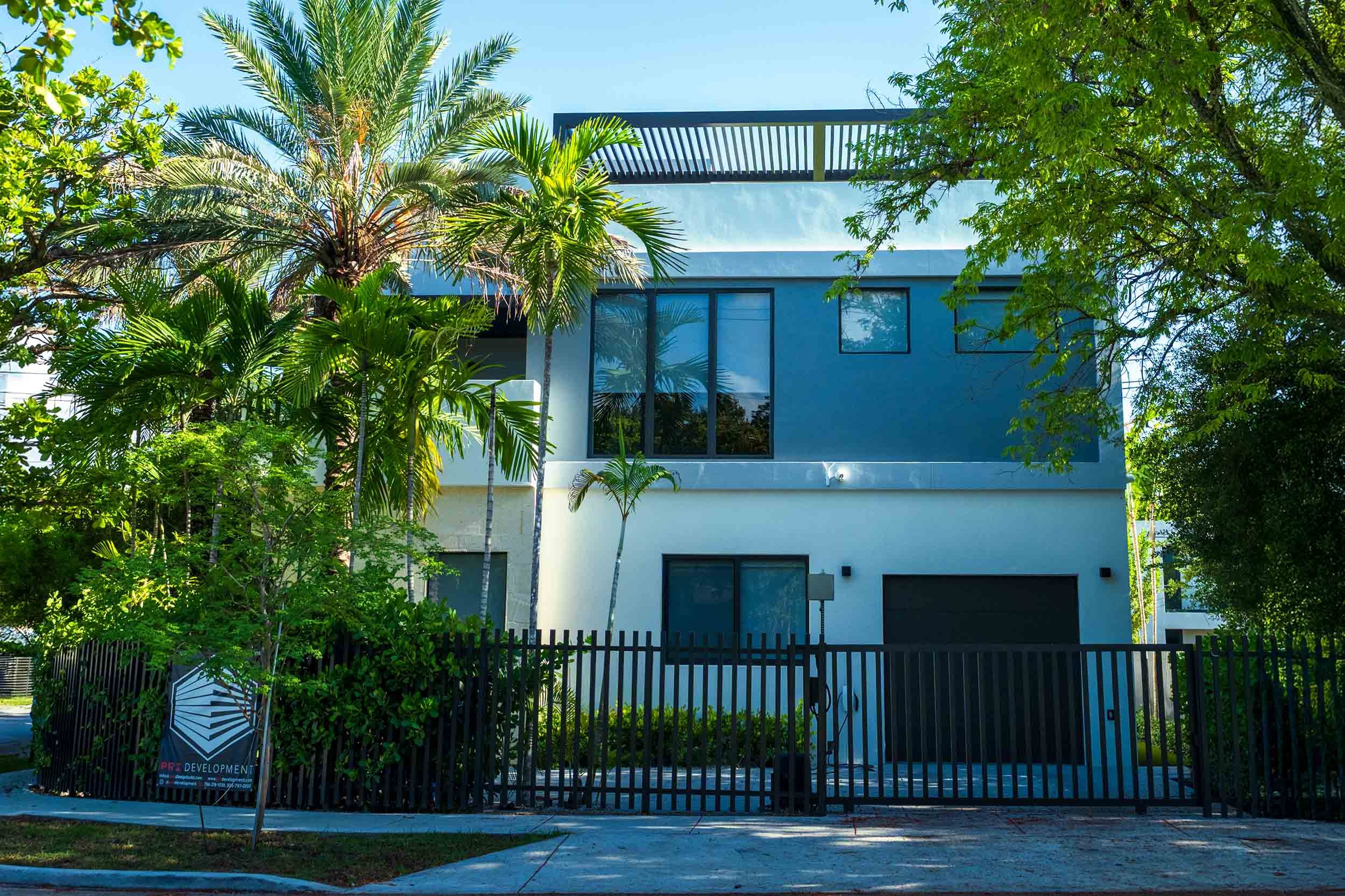 New construction home with developer sign out front, Buena Vista Miami