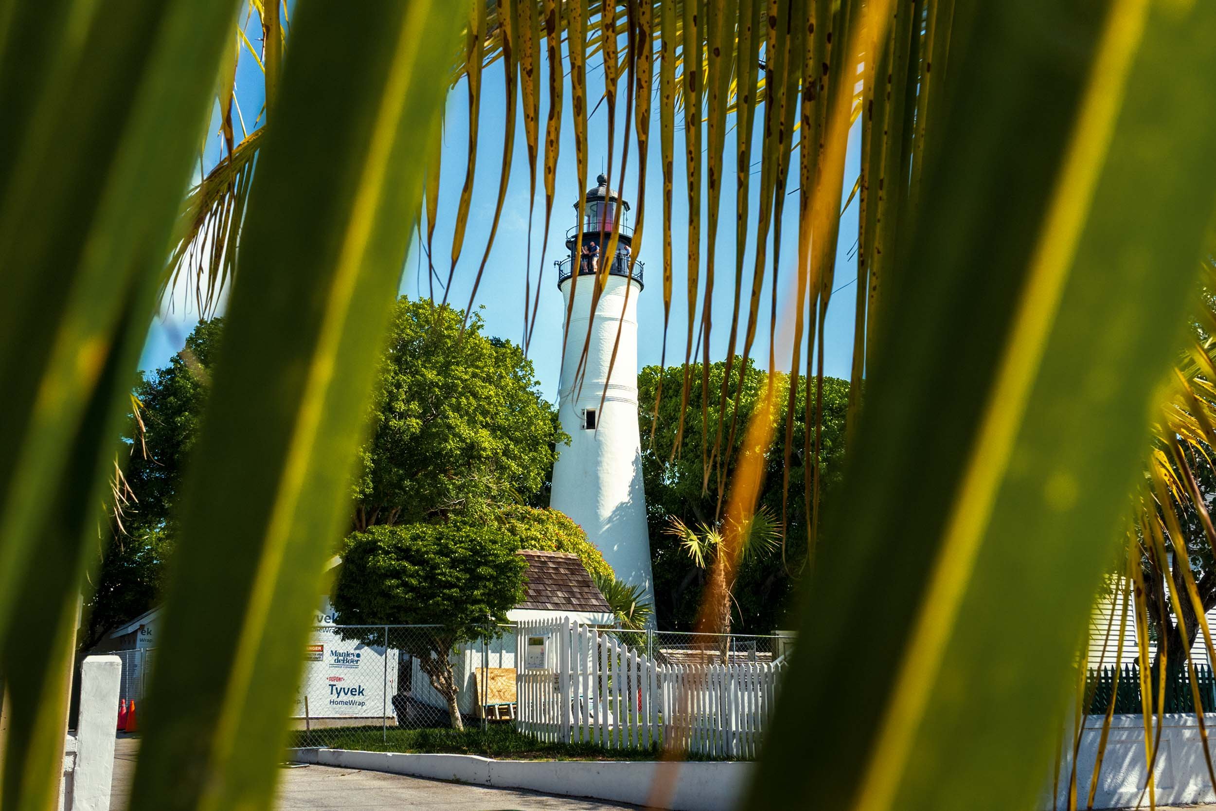 Key West Lighthouse historic landmark Florida Keys tourist attraction palm trees blue sky