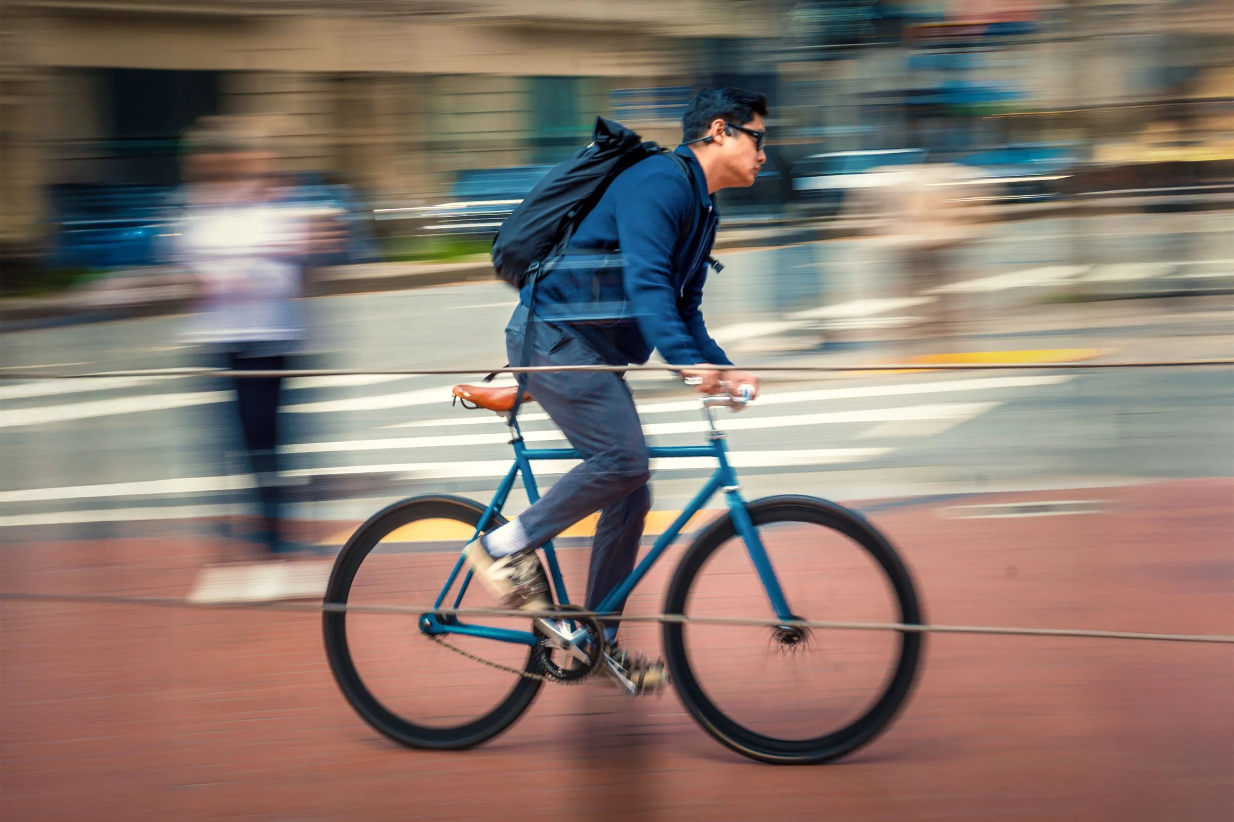 A panning shot of a bike rider in downtown Miami