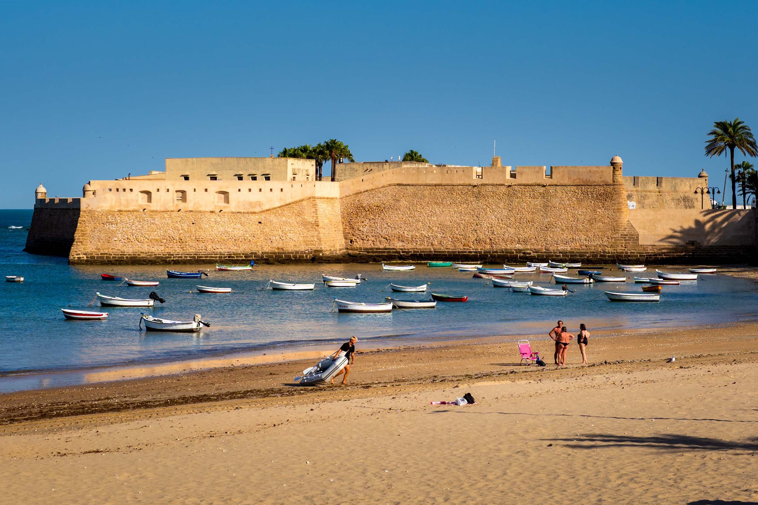 Cadiz Spain beach fortress historic castle fishing boats Andalusia travel destination sunny coastline
