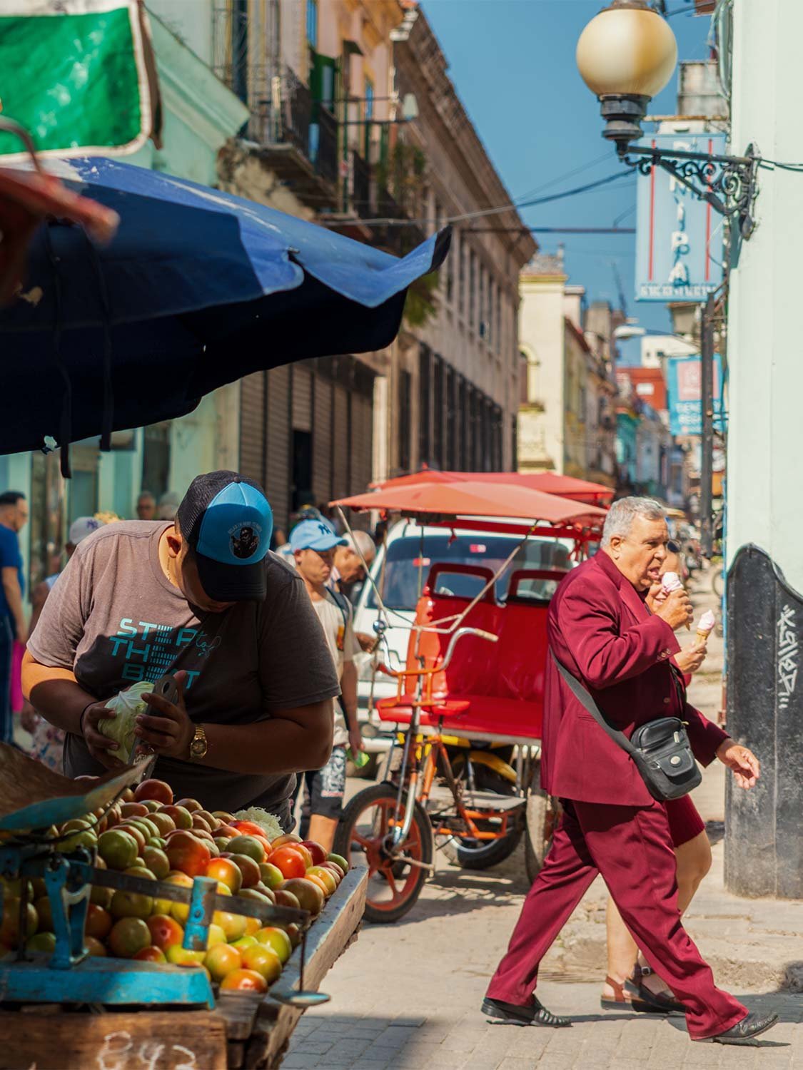 Havana street market scene, fruit vendor, bicitaxi, colorful Cuban street photography, travel lifestyle