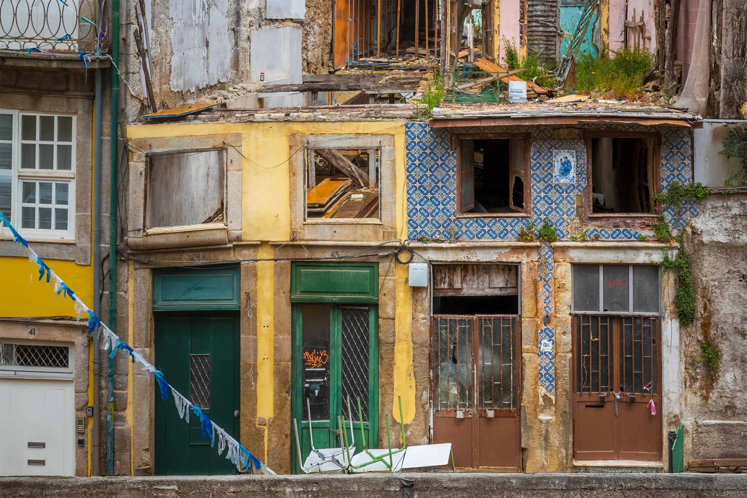 Derelict townhouses with blue azulejo tiles in Ribeira, Porto