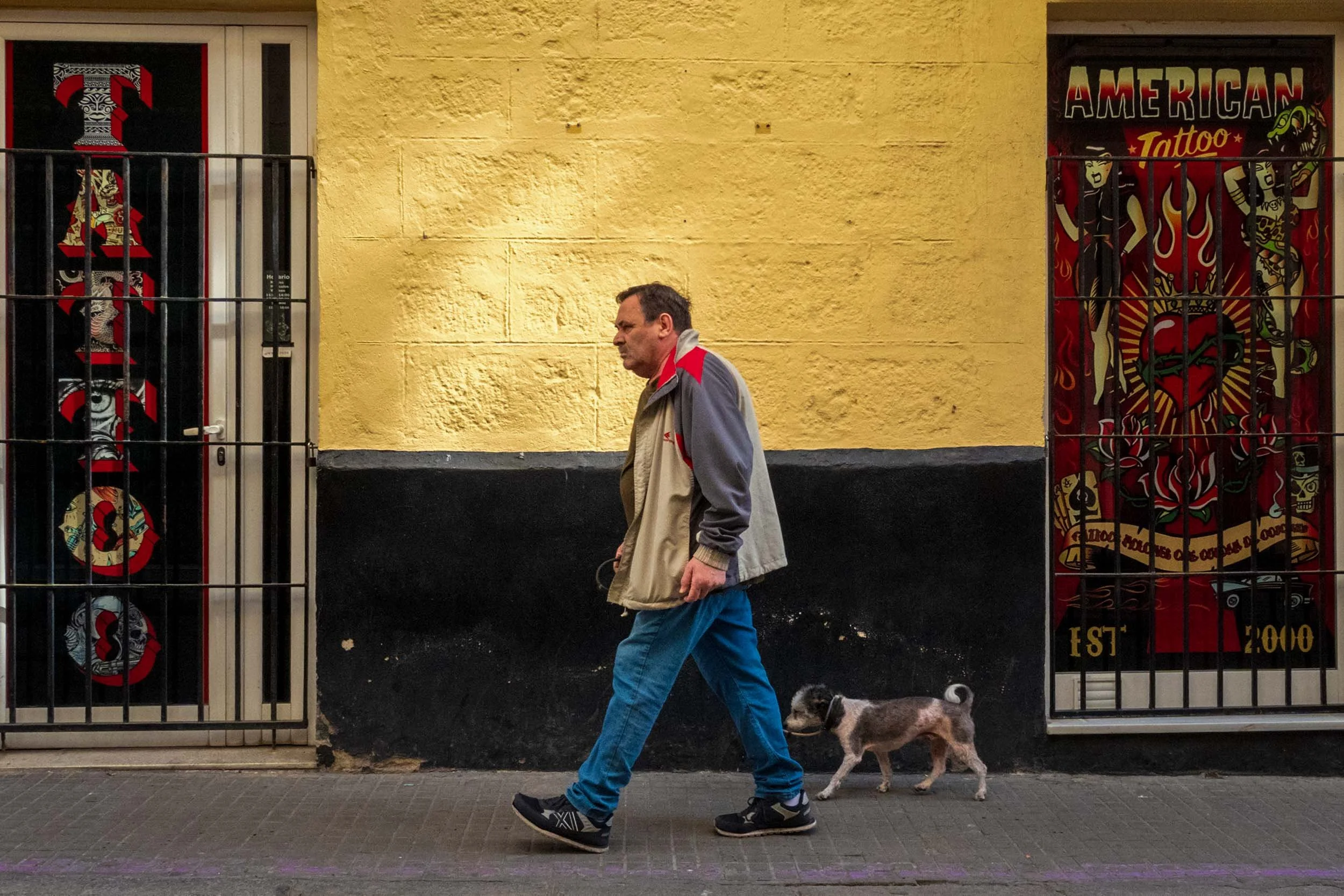 Cadiz Spain street photography tattoo shop man dog urban wall art American Tattoo EST 2000