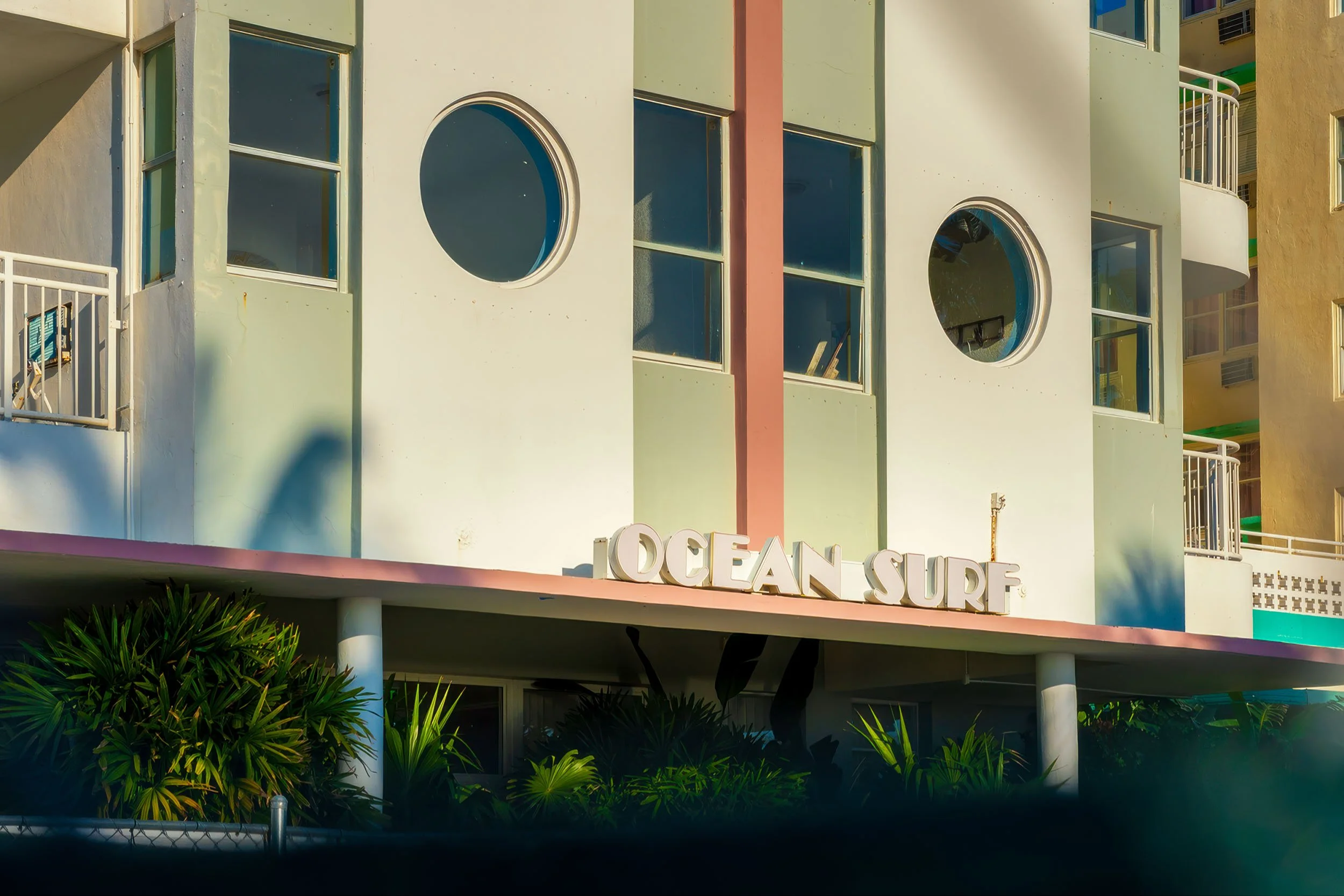 OCEAN SURF hotel sign and porthole windows with palm shadows, Ocean Terrace Miami