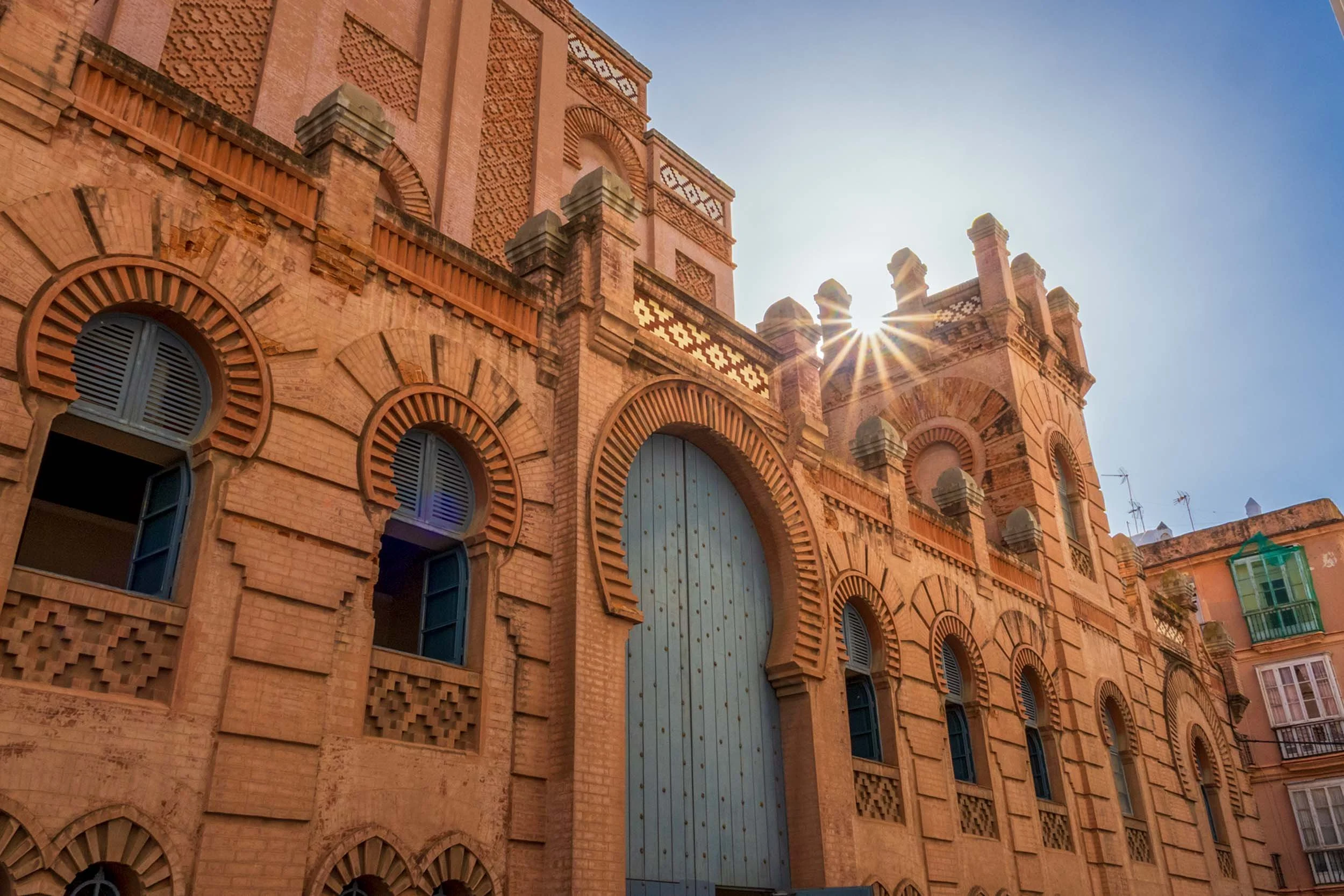 Cadiz Spain historic Moorish architecture brick building arched windows sunburst travel landmark