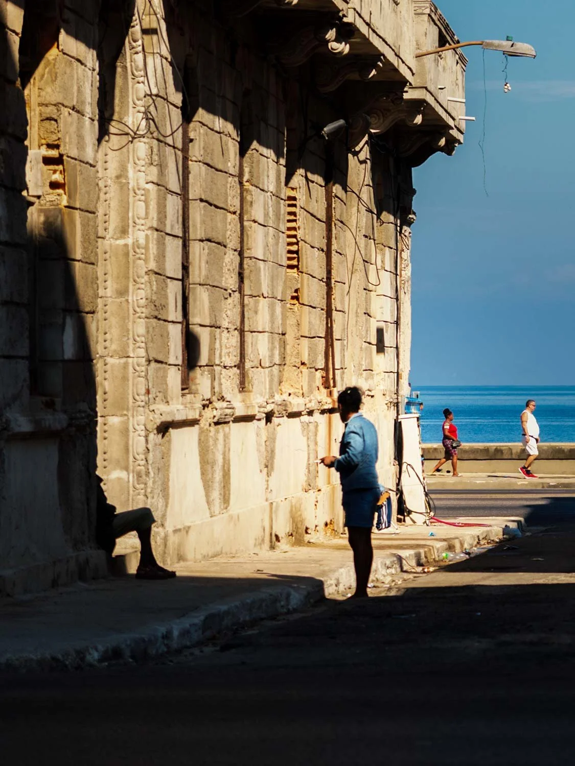 People walking down the Malecon in Havana Cuba