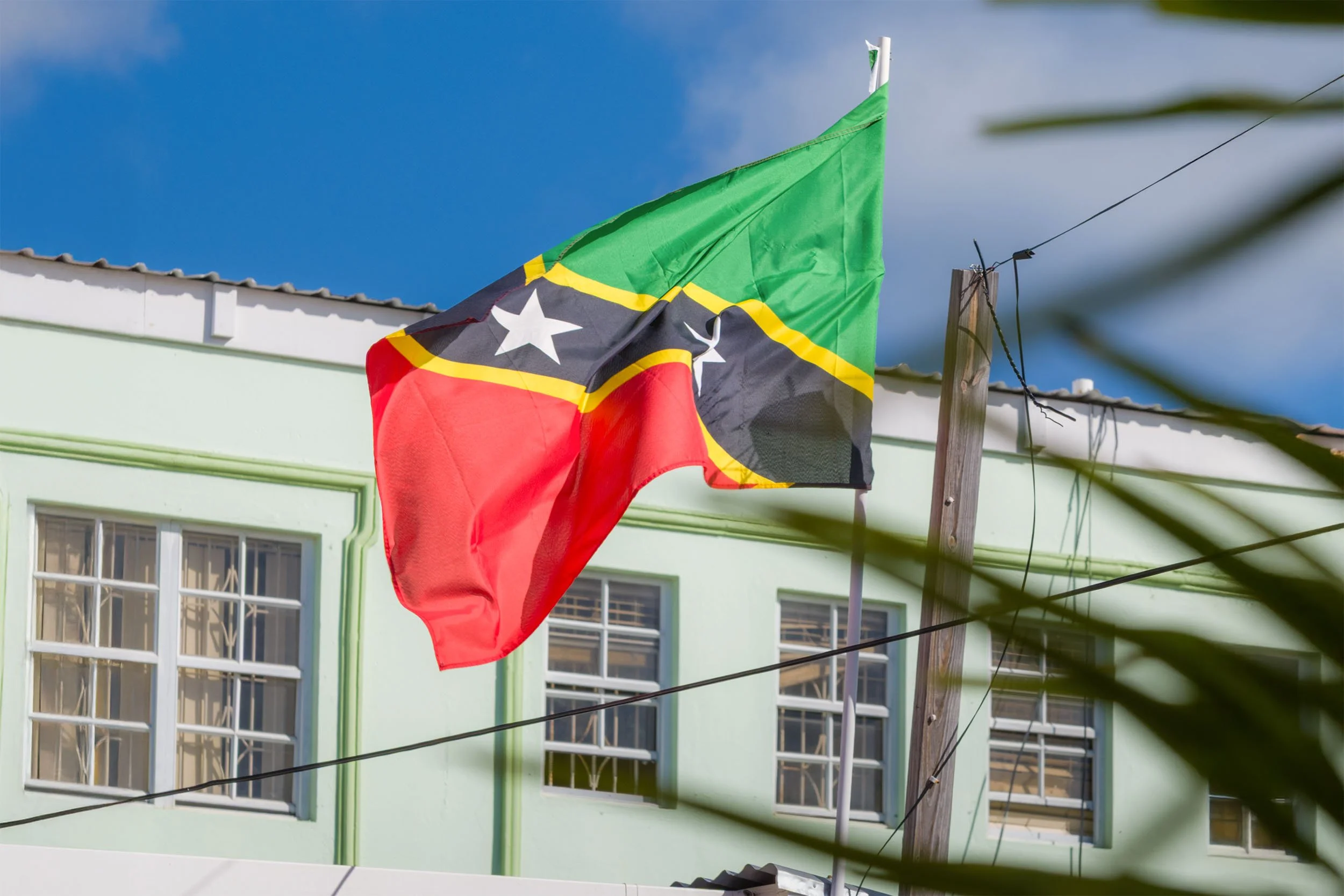 The national flag of St Kitts and Nevis blows in the wind at cruise port in Basseterre