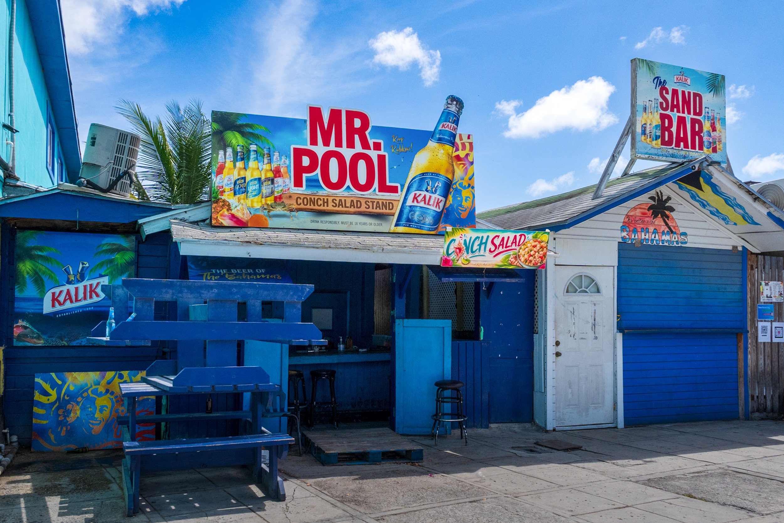 Mr. Pool Conch Salad Stand and The Sand Bar at Arawak Cay Nassau, Bahamas featuring Kalik beer signs.