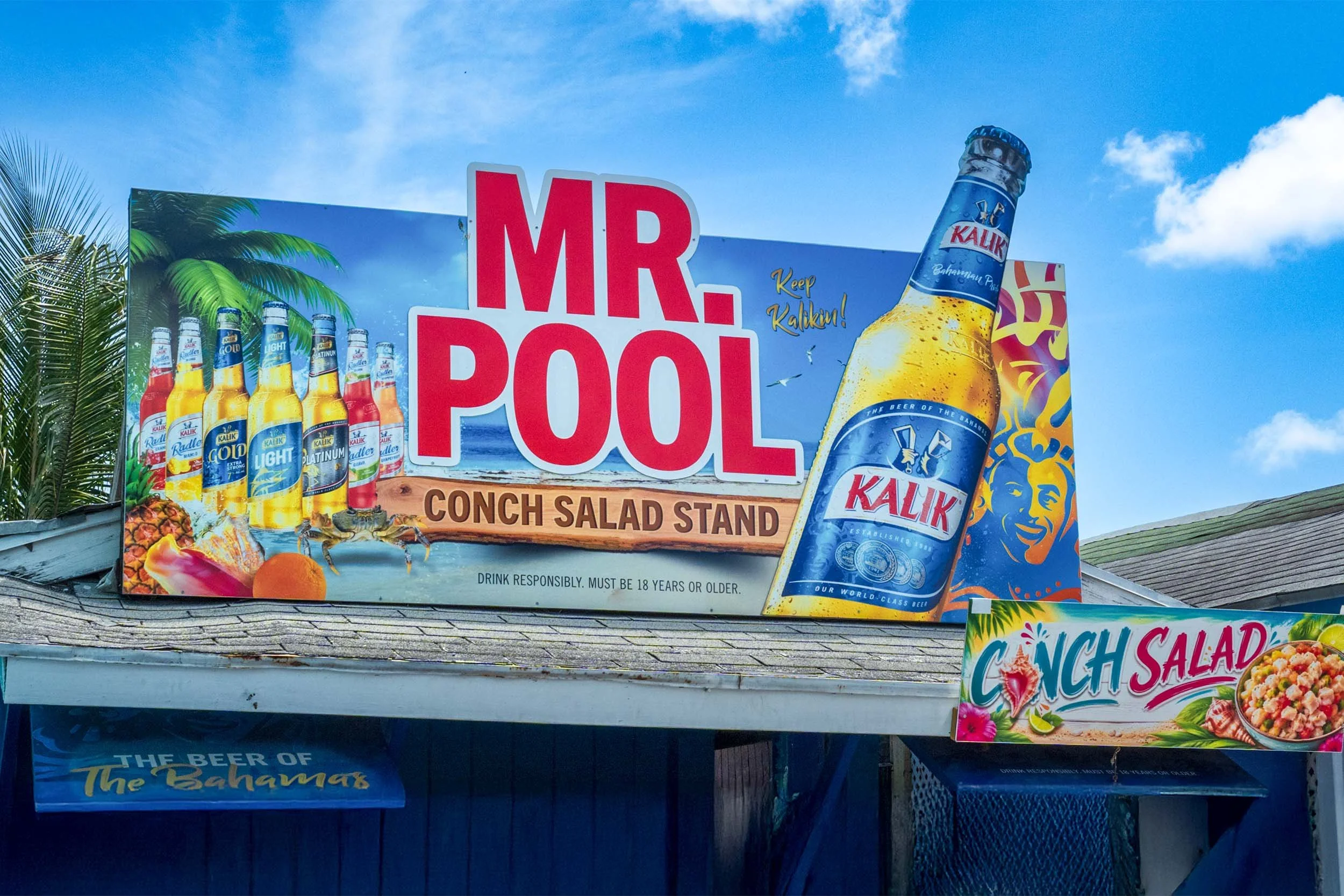 Mr. Pool Conch Salad Stand Bahamas Kalik beer sign Nassau local food vendor tropical outdoor restaurant