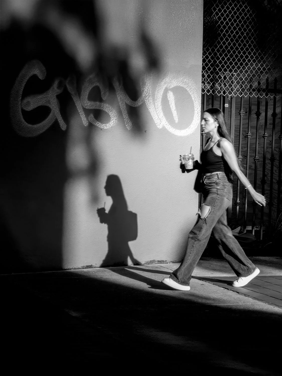 Downtown Miami street photography black and white woman walking urban graffiti wall shadow candid city life