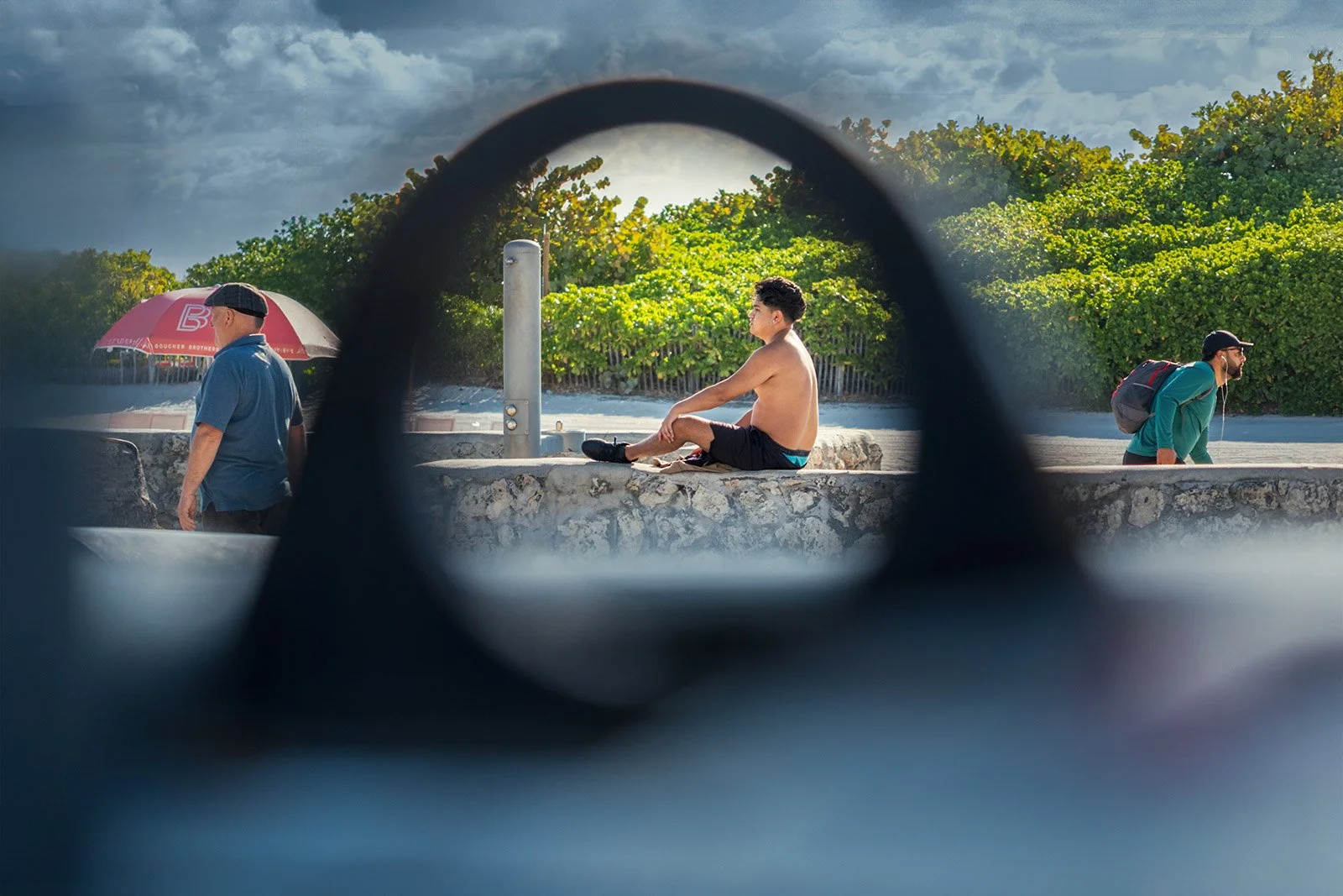 Framing a  young man behind an opening in Lummus Park South Beach Miami