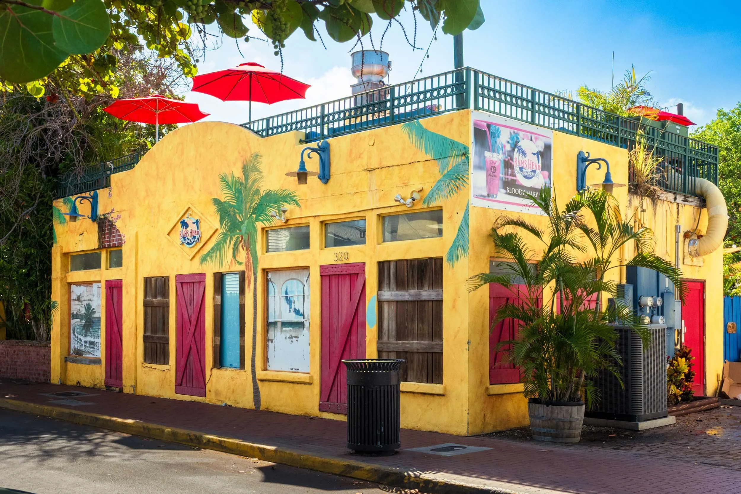Key West bar restaurant yellow building red umbrellas rooftop patio Duval Street tropical architecture Florida Keys