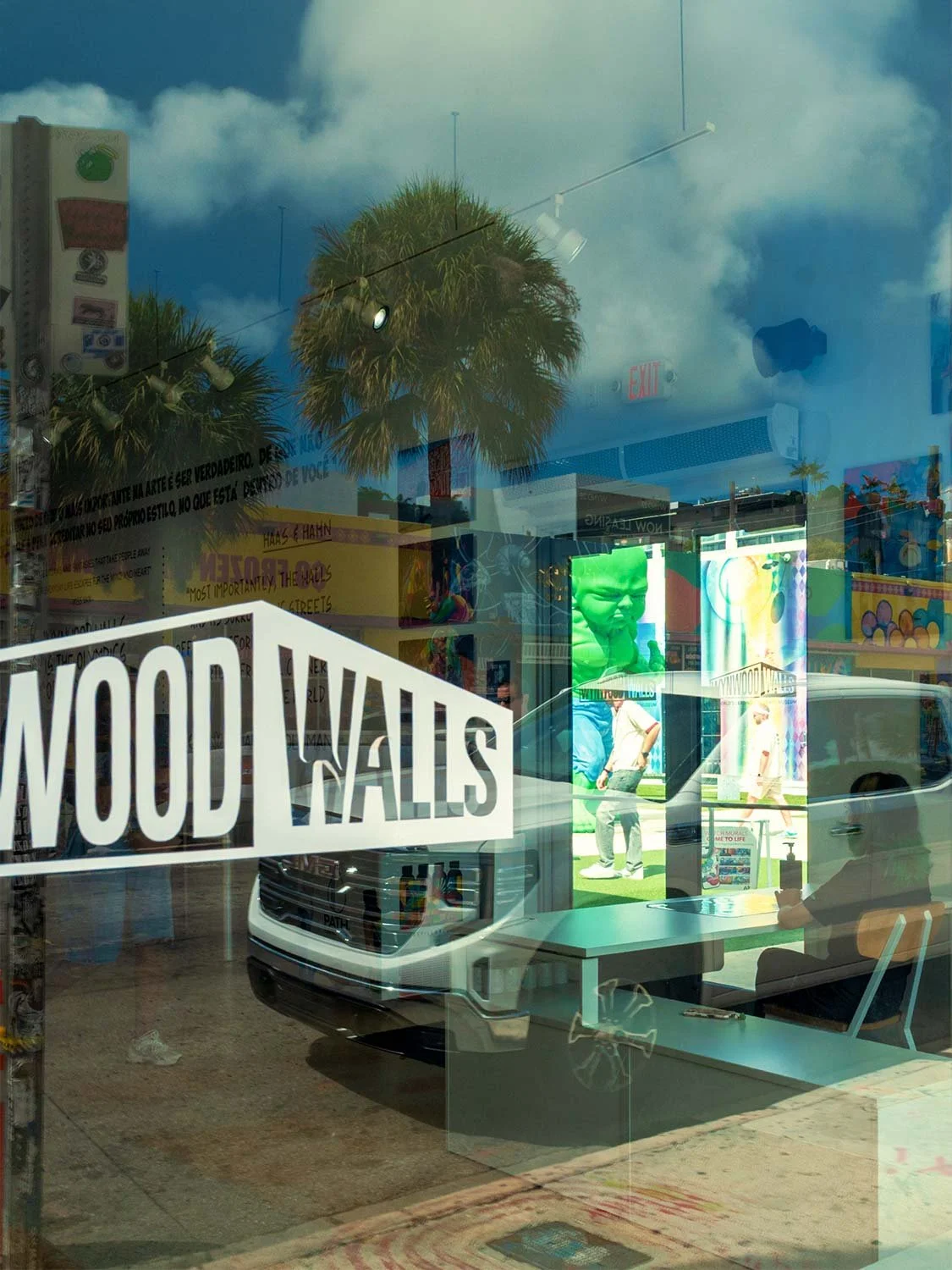 Wynwood Walls Miami street art district storefront sign reflection murals urban art gallery Florida