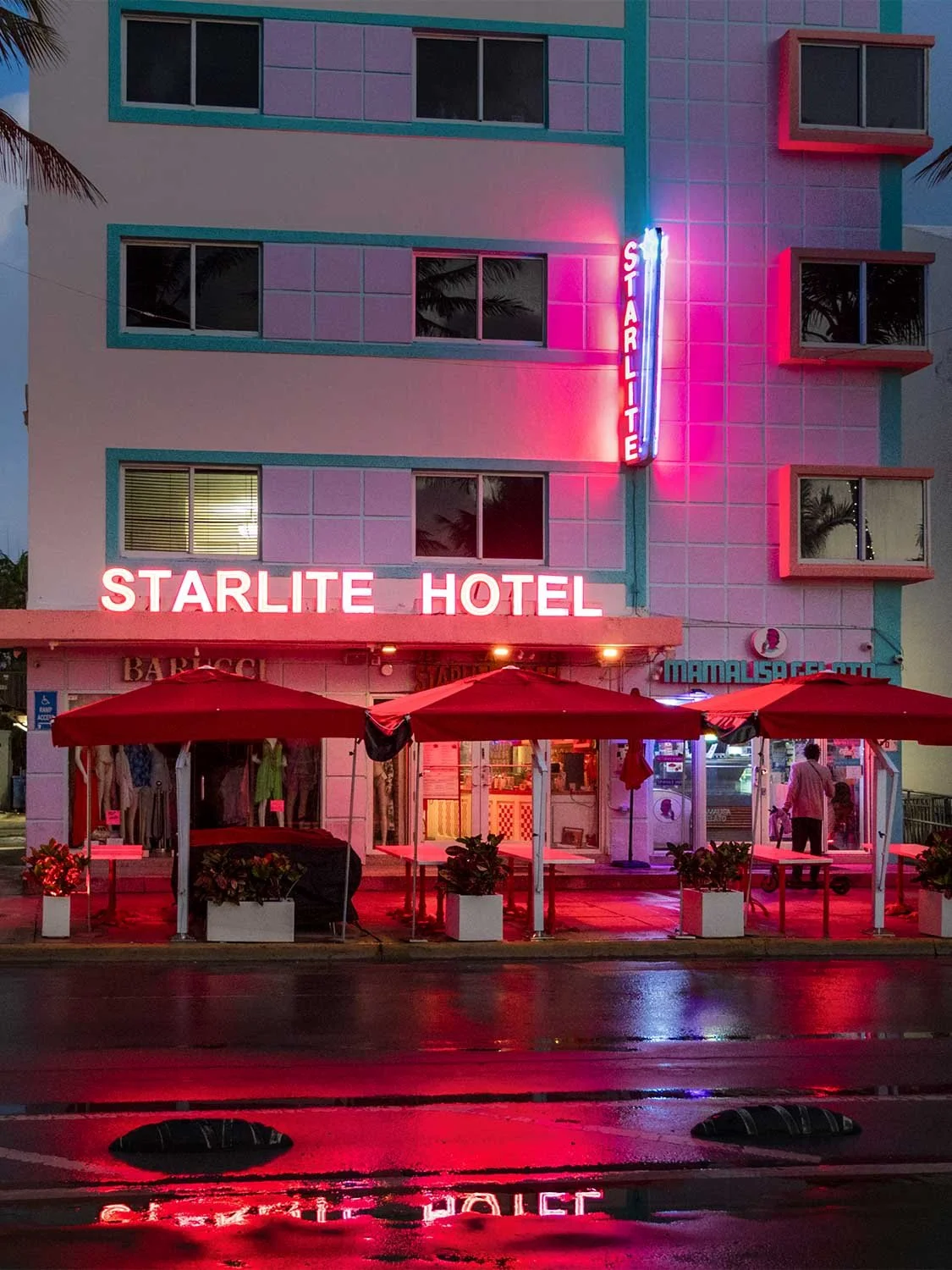 Starlite Hotel Miami Beach neon sign night Art Deco architecture outdoor dining red umbrellas Ocean Drive