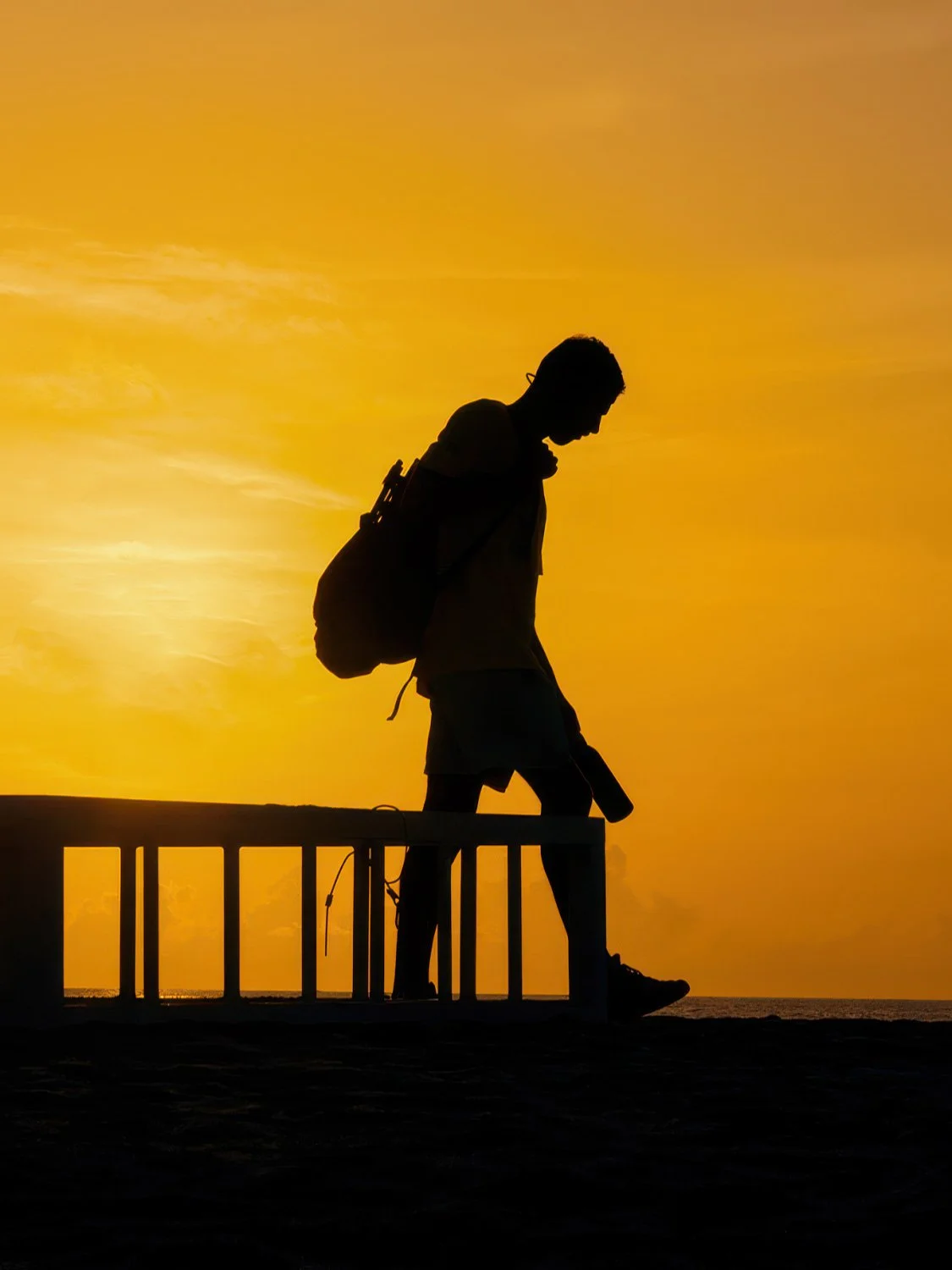 South Beach sunrise silhouette backpacker travel photography golden hour pier ocean view
