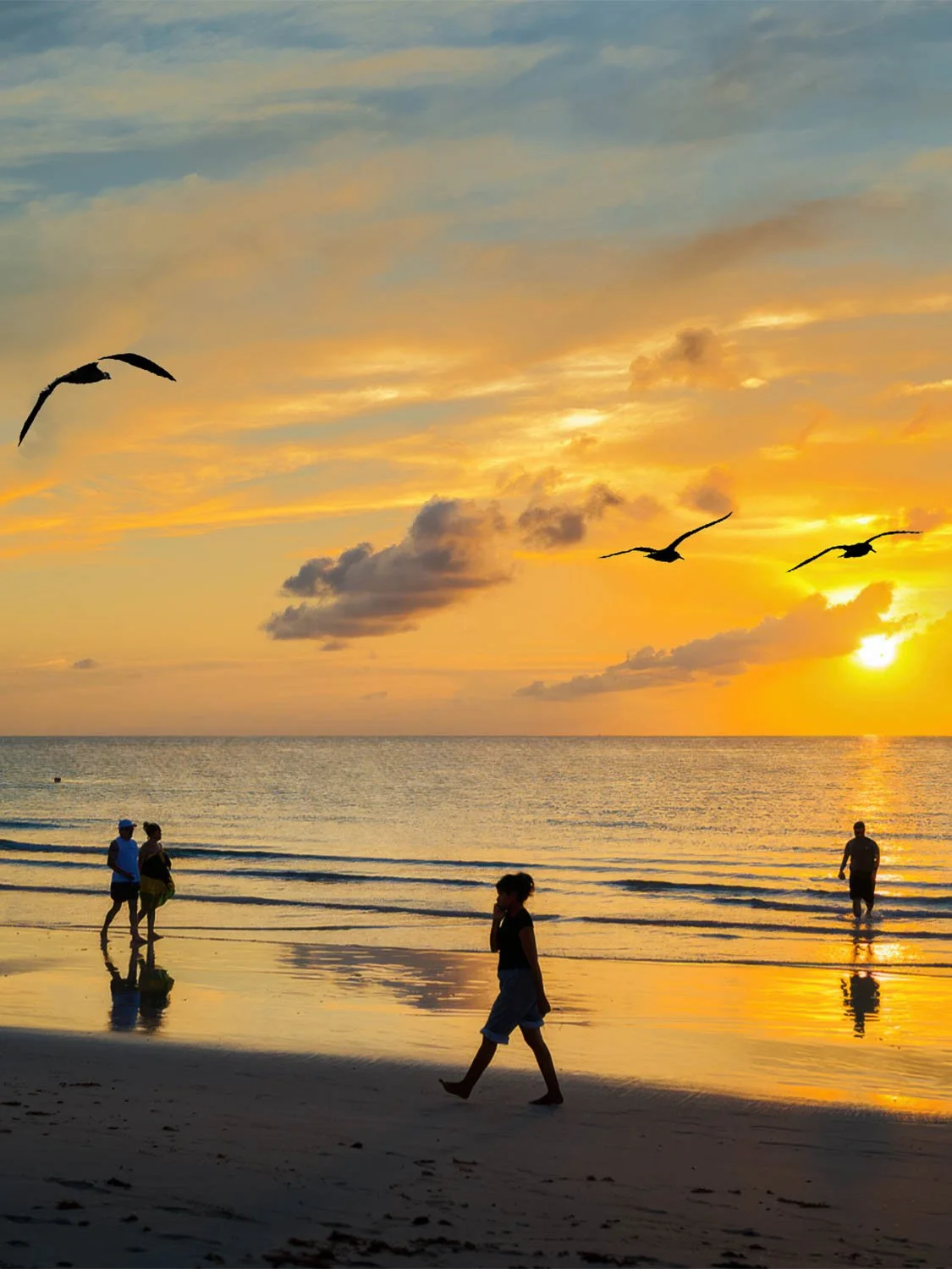 South Beach sunrise with silhouetted beachgoers, flying pelicans, and glowing golden ocean horizon at sunset.